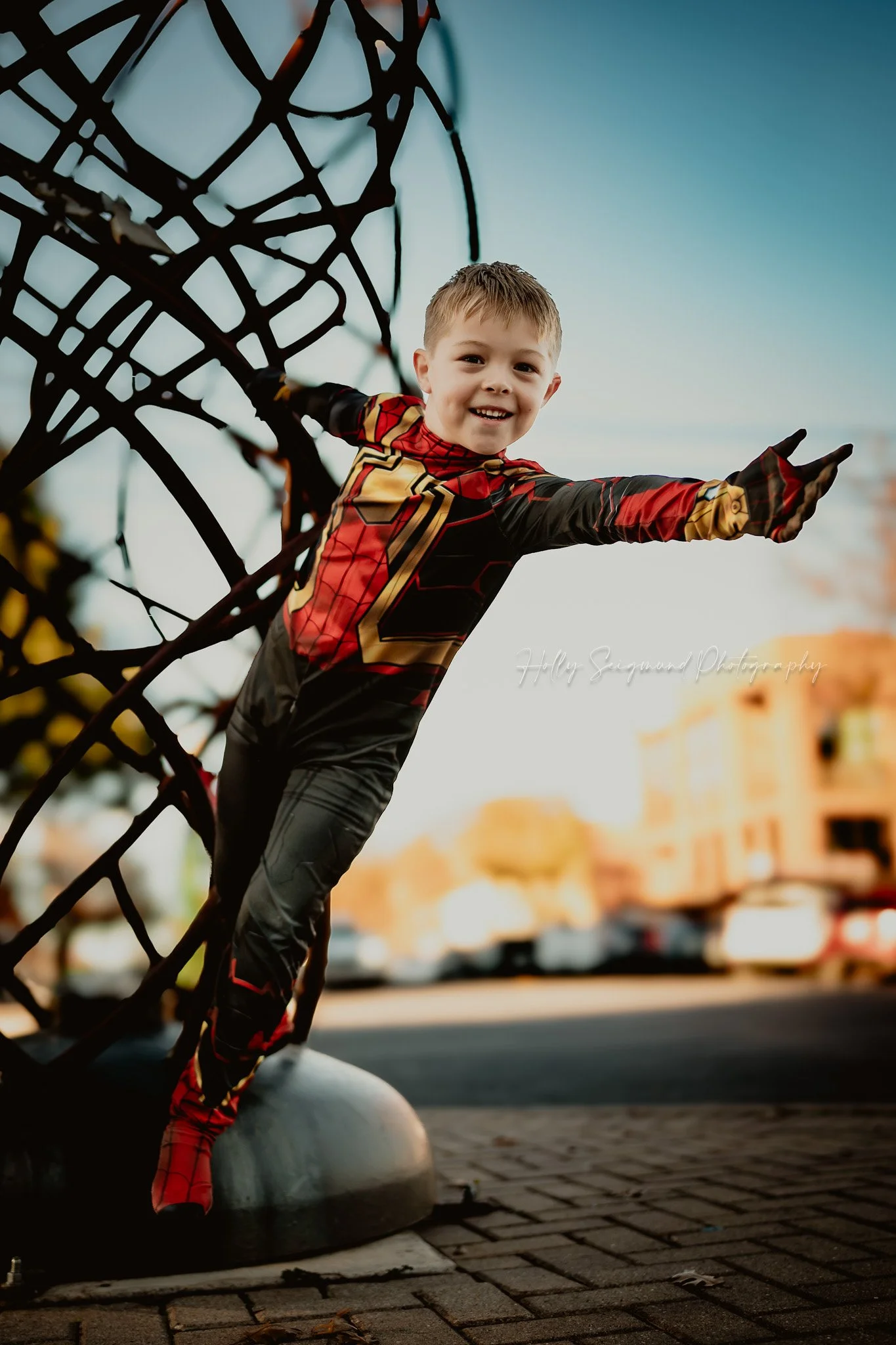 little boy dressed as Spiderman during an outdoor birthday photoshoot in Georgetown TX with dramatic lighting