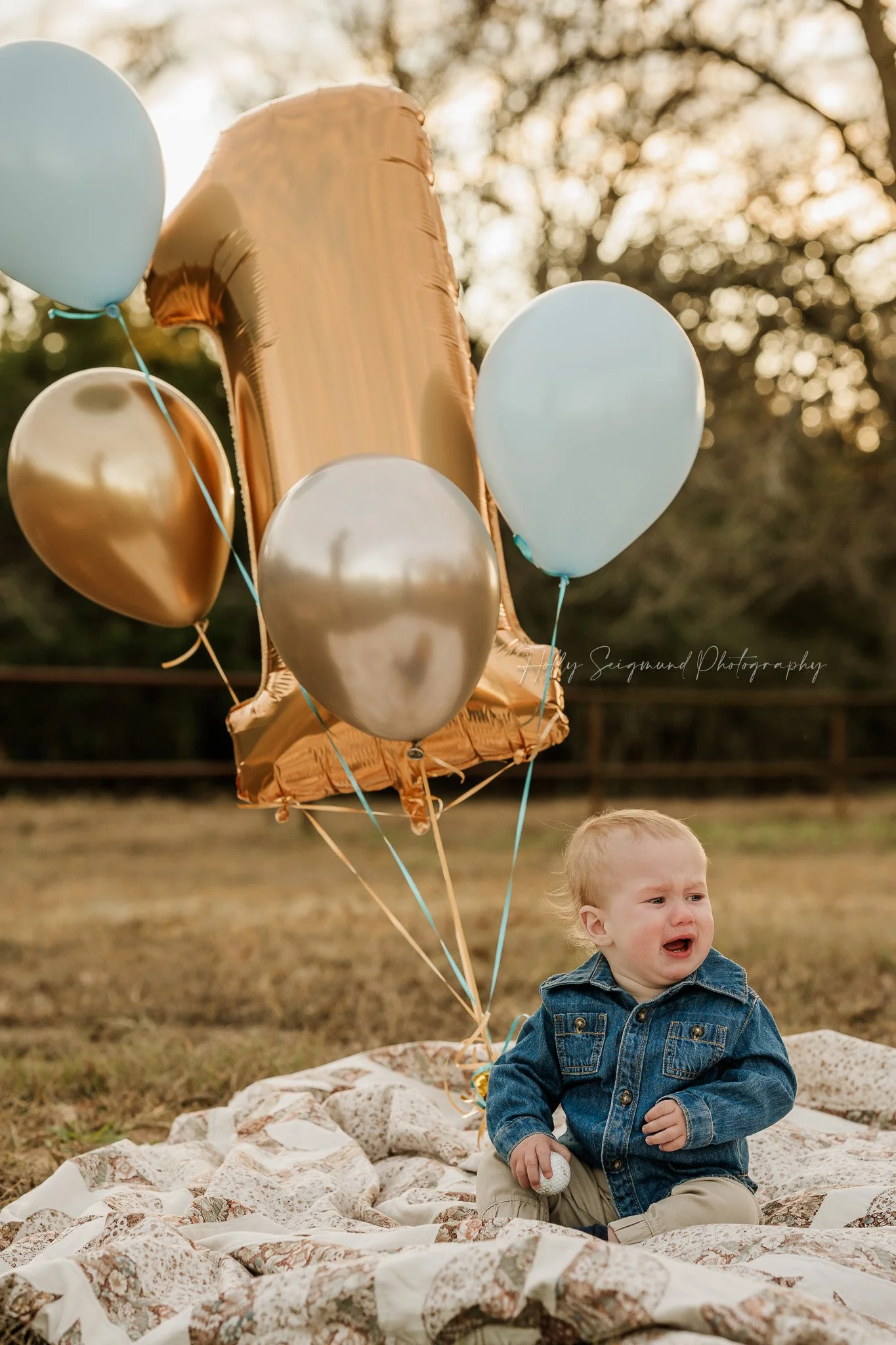 Natural light outdoors first birthday session with a baby boy and number one balloon in Central Texas