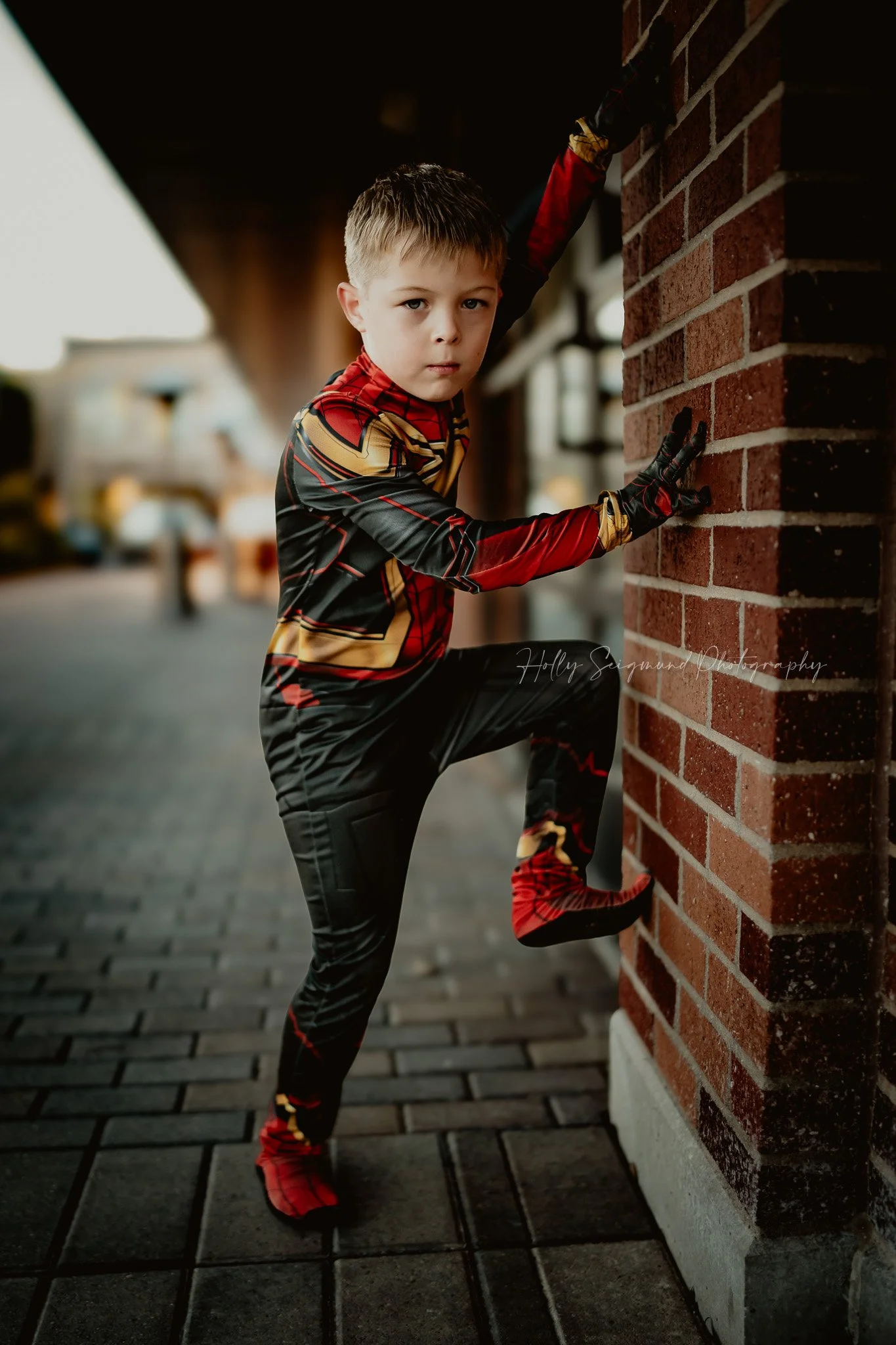 6-year-old child in Spiderman outfit posing for a birthday portrait session in Georgetown TX