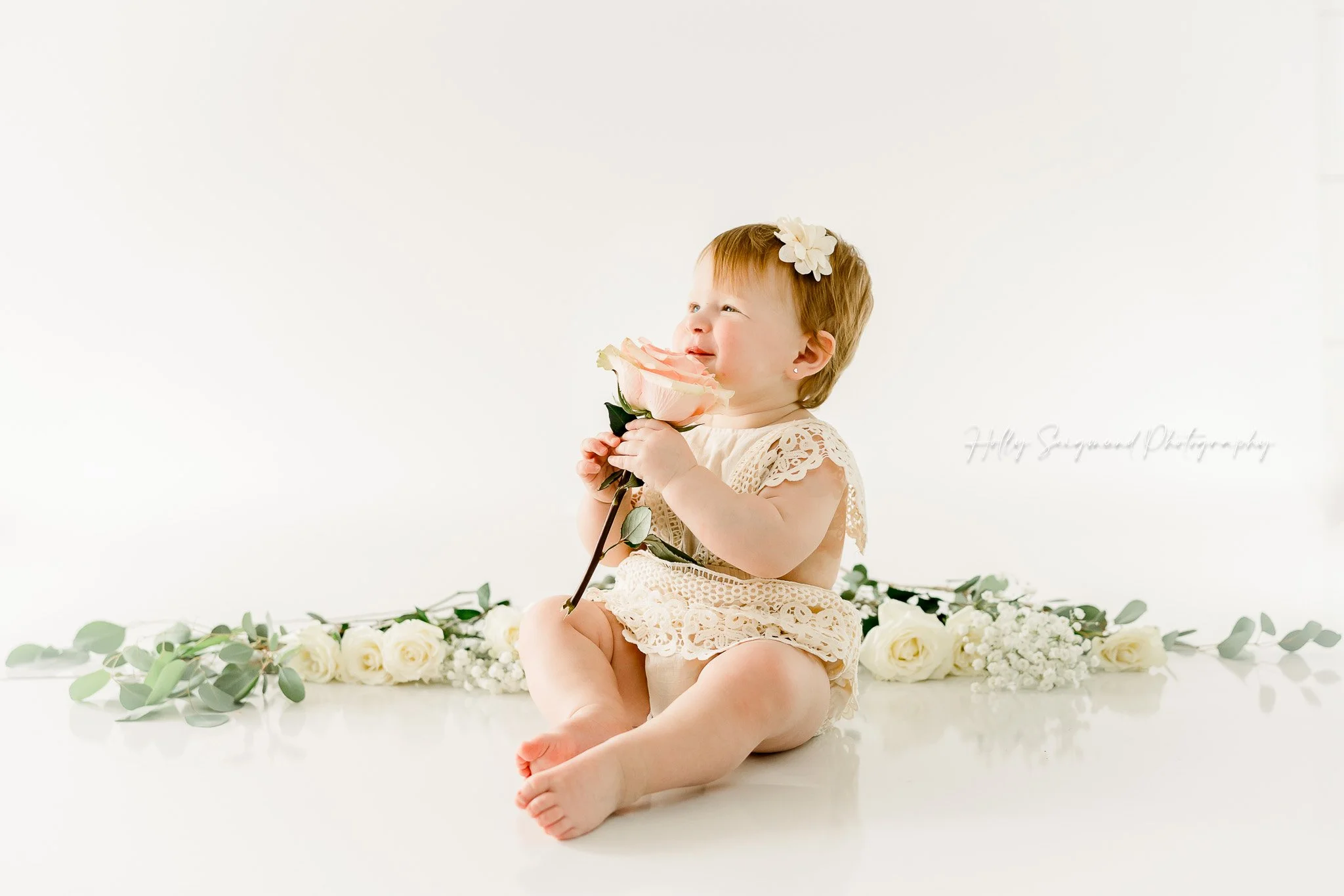 simple white and floral studio in Central Texas for first birthday sessions
