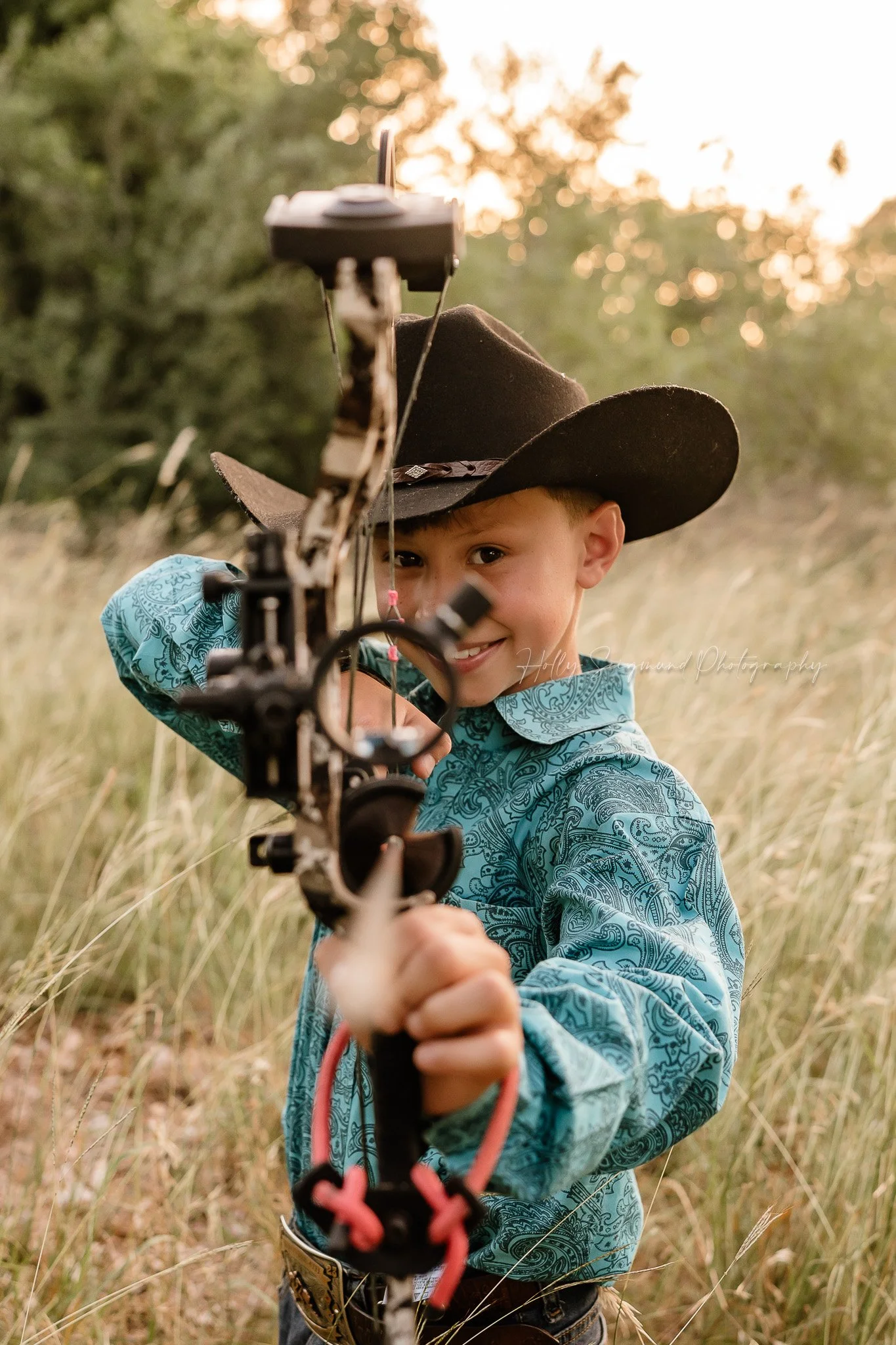 rustic style birthday session of a boy with a bow in Lee County Texas