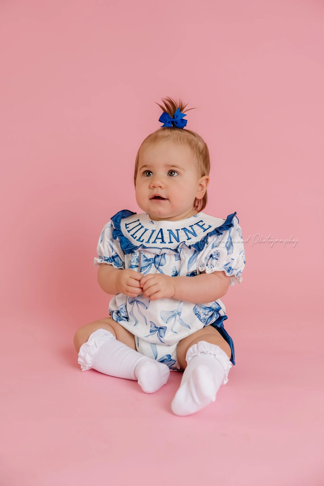 Simple pink backdrop girls first birthday photos with flash photography in a studio in Central Texas