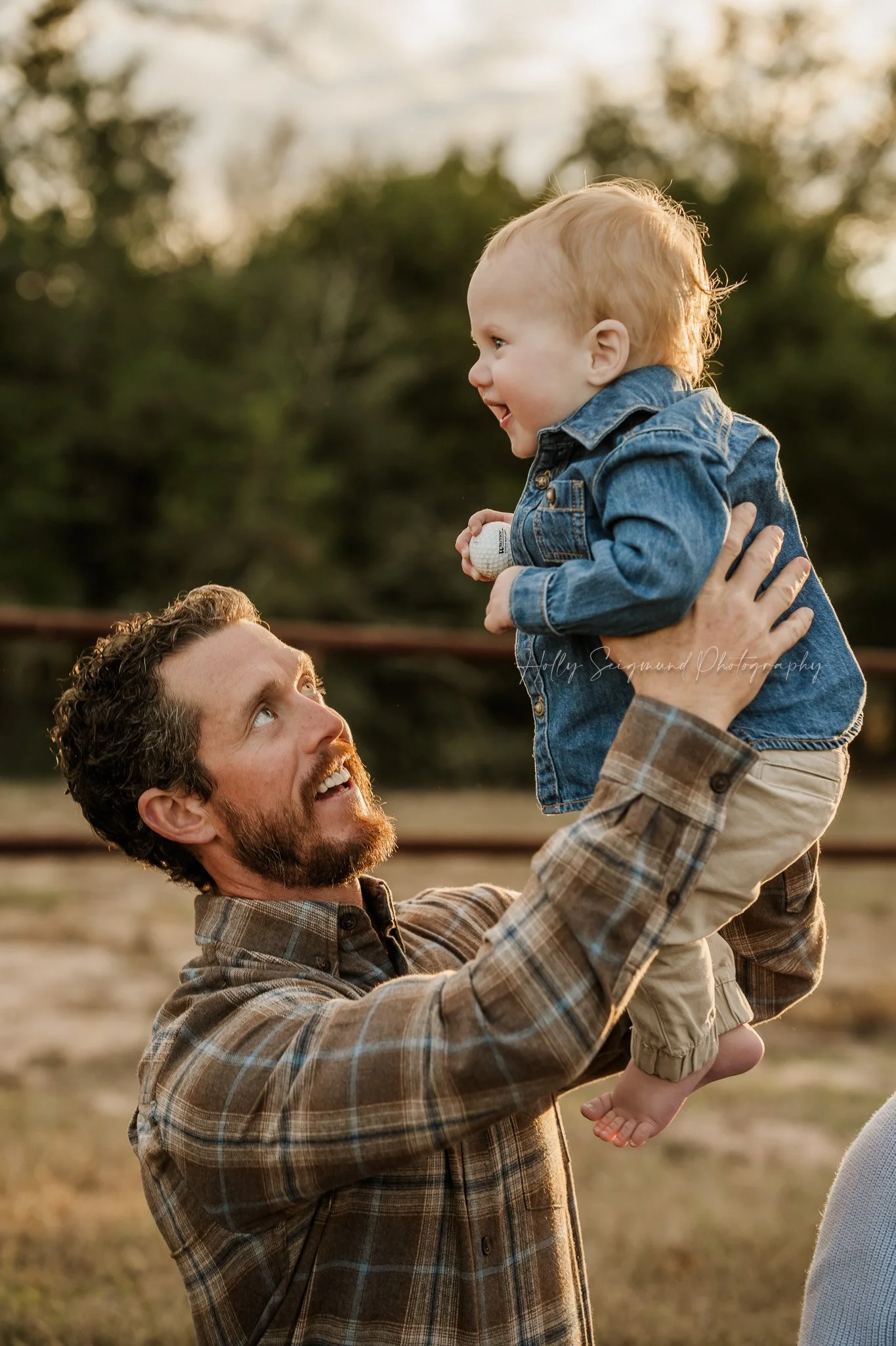 Dad and son during outdoor first birthday session in Central Texas