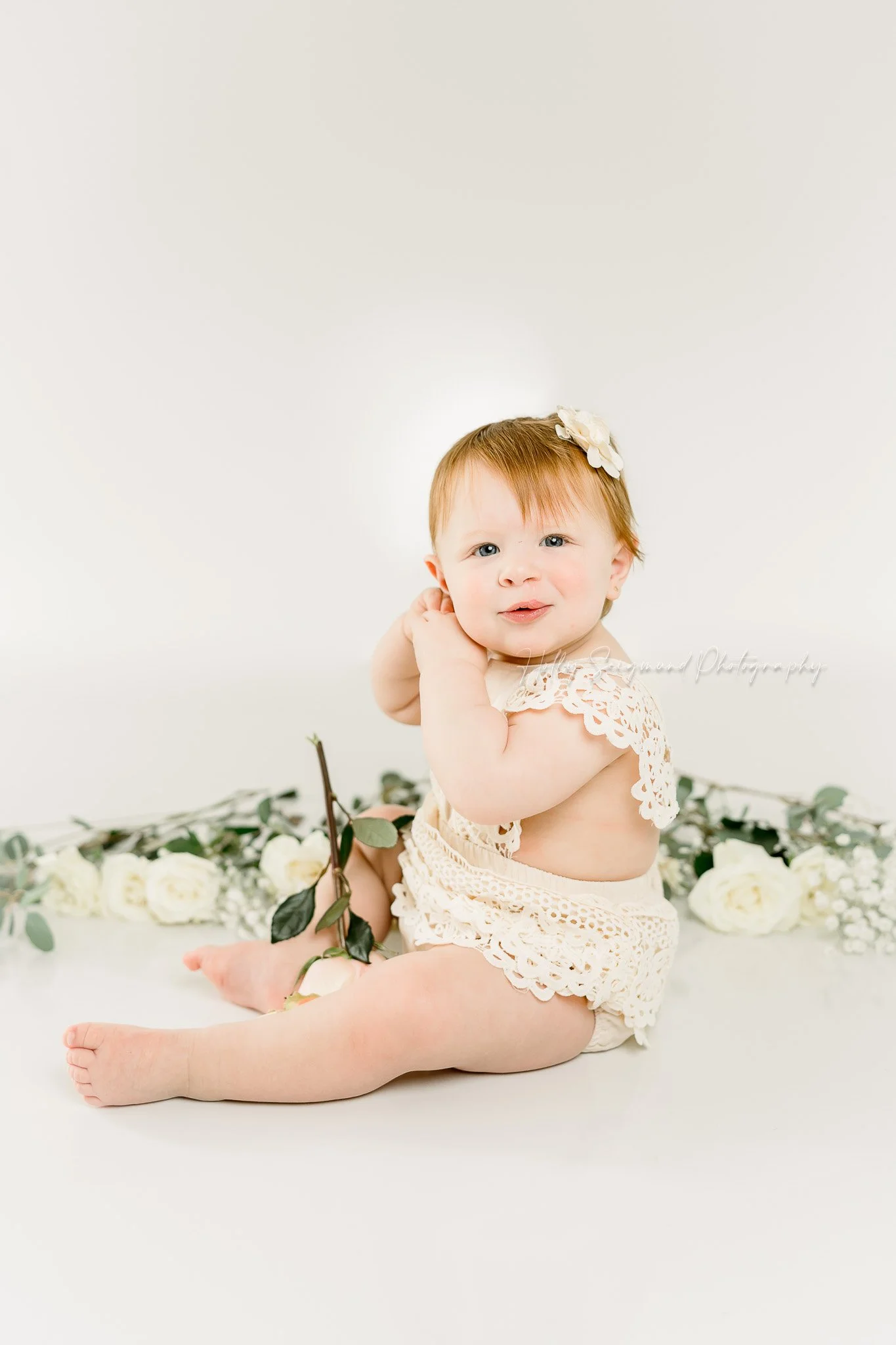 simple first birthday photos with florals and white backdrop in Central Texas