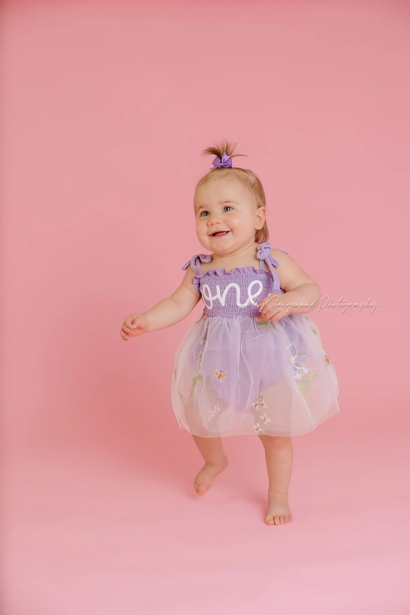 Simple pink backdrop girls first birthday photos with flash photography in a studio near Lexington, Texas