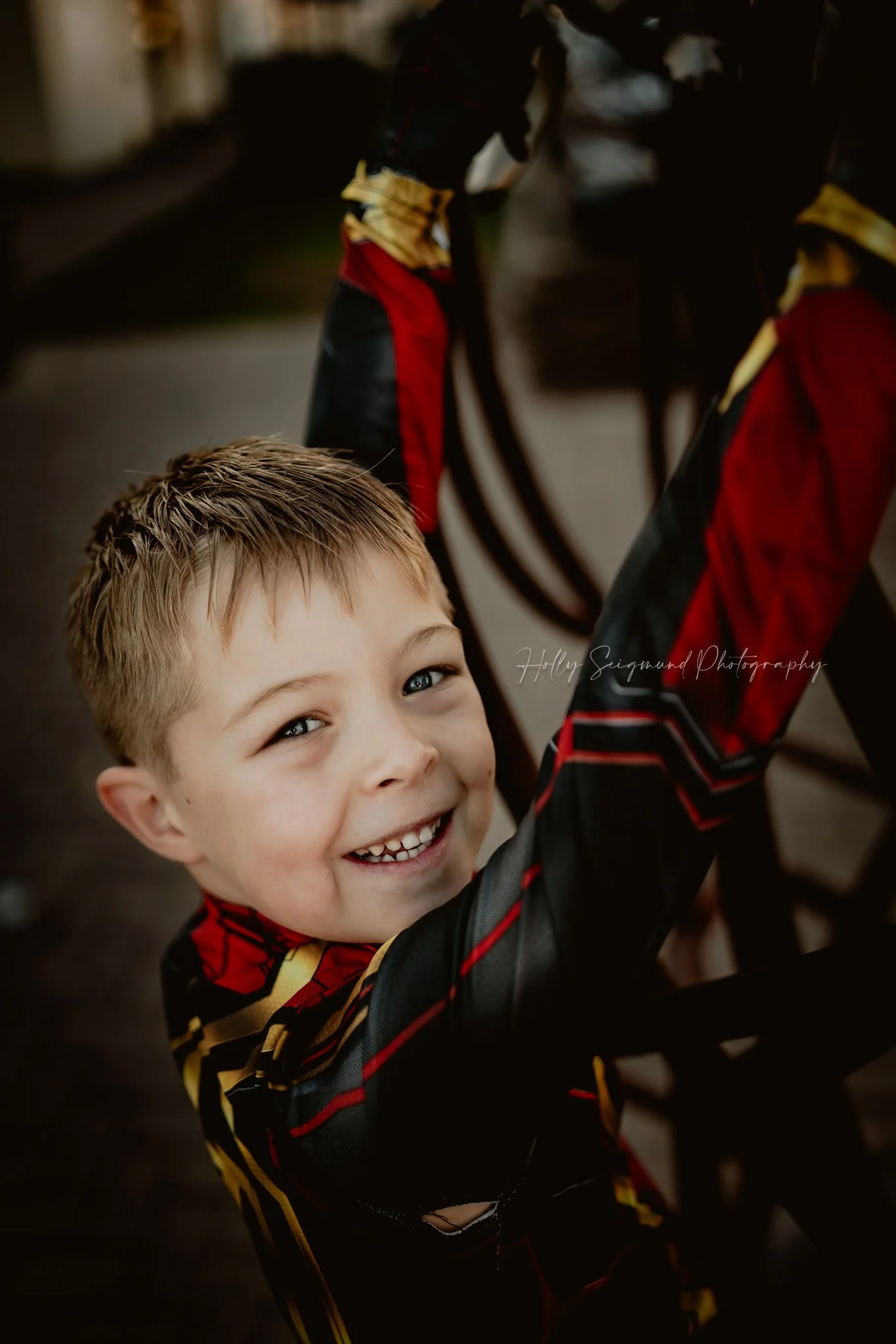 6th birthday portrait of a child in superhero costume photographed outdoors in Georgetown Texas