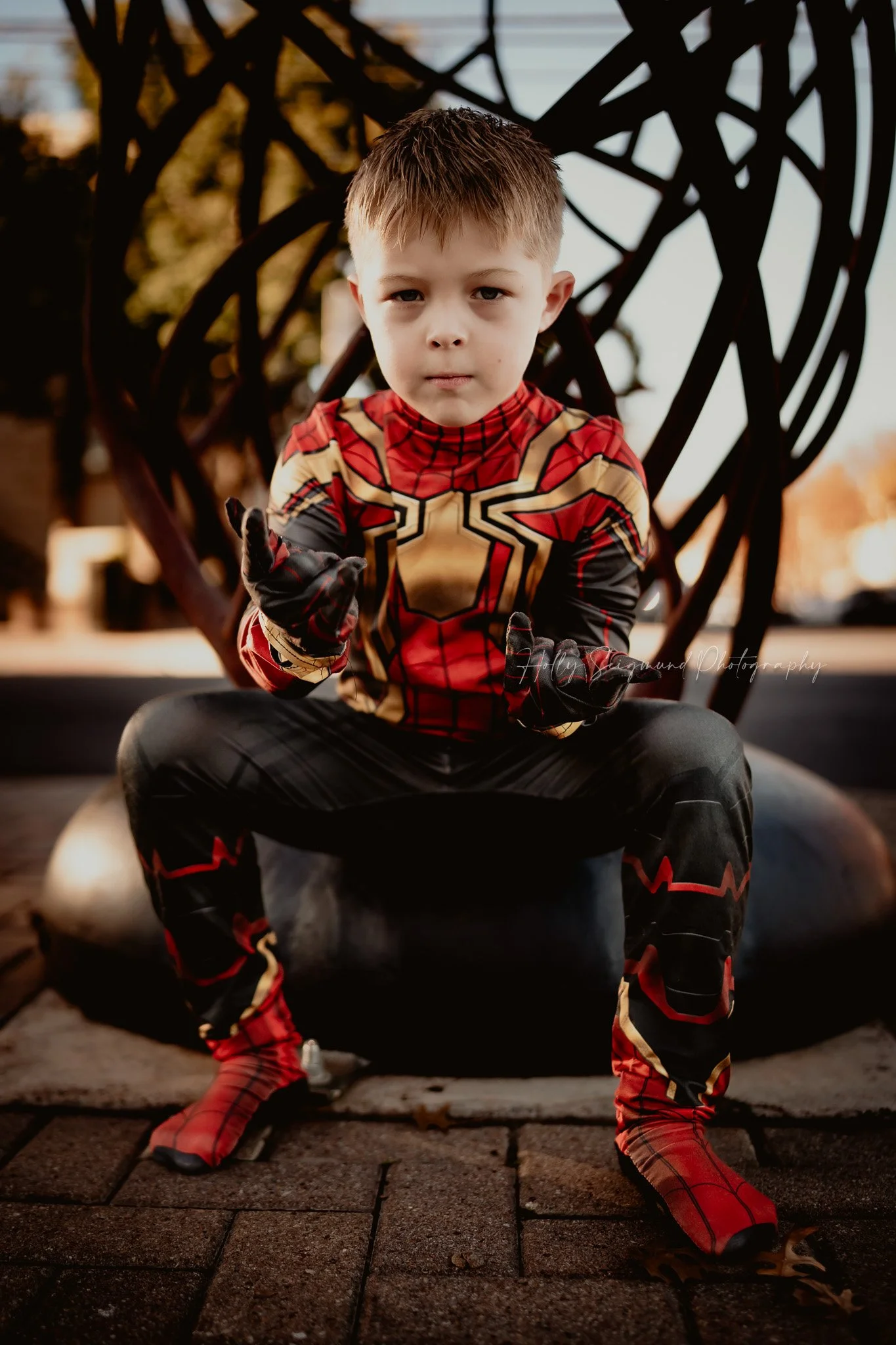 young boy celebrating his 6th birthday in a superhero costume during a photoshoot in Georgetown Texas