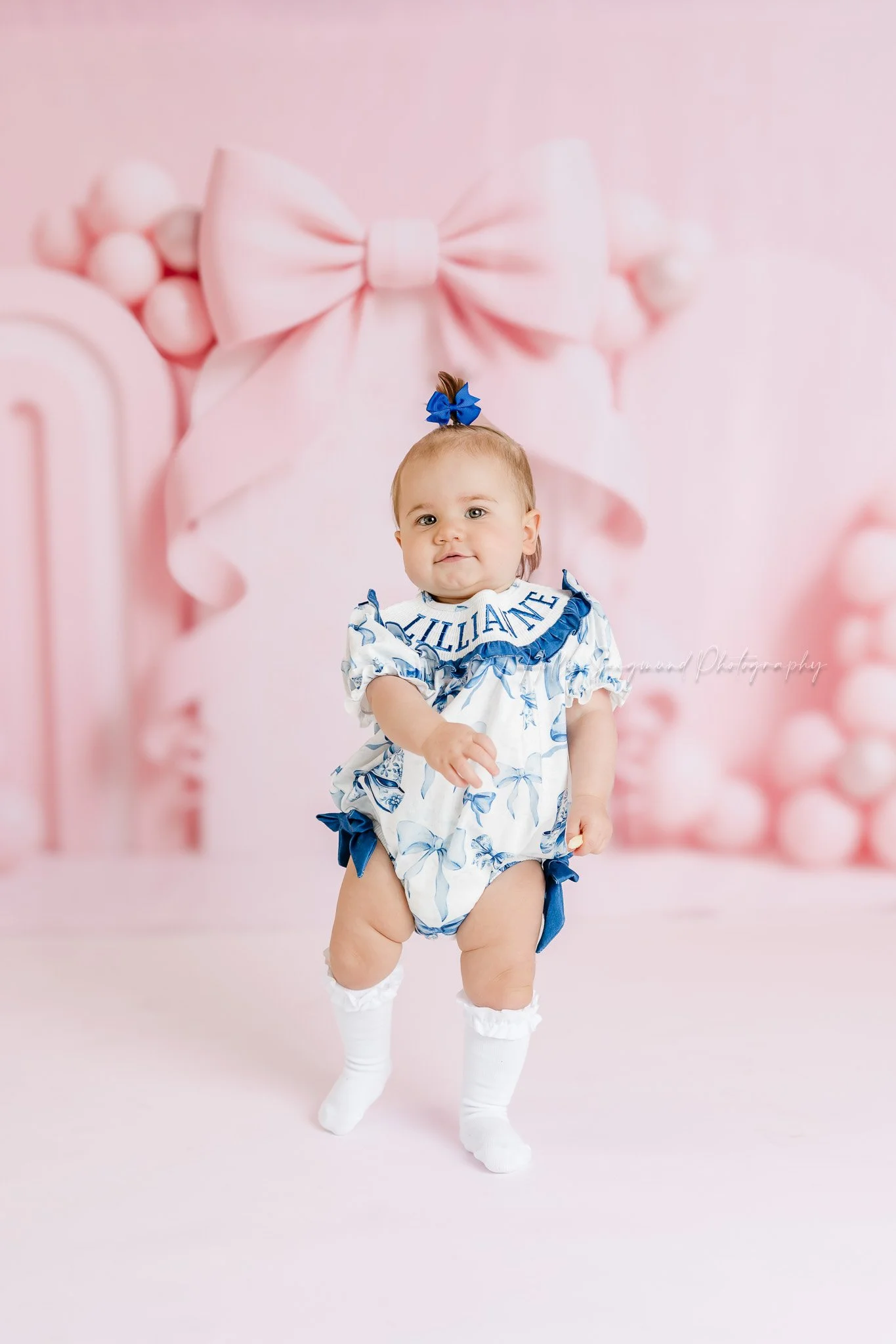 Birthday girl photos with pink bow back drop in studio near Elgin, Texas