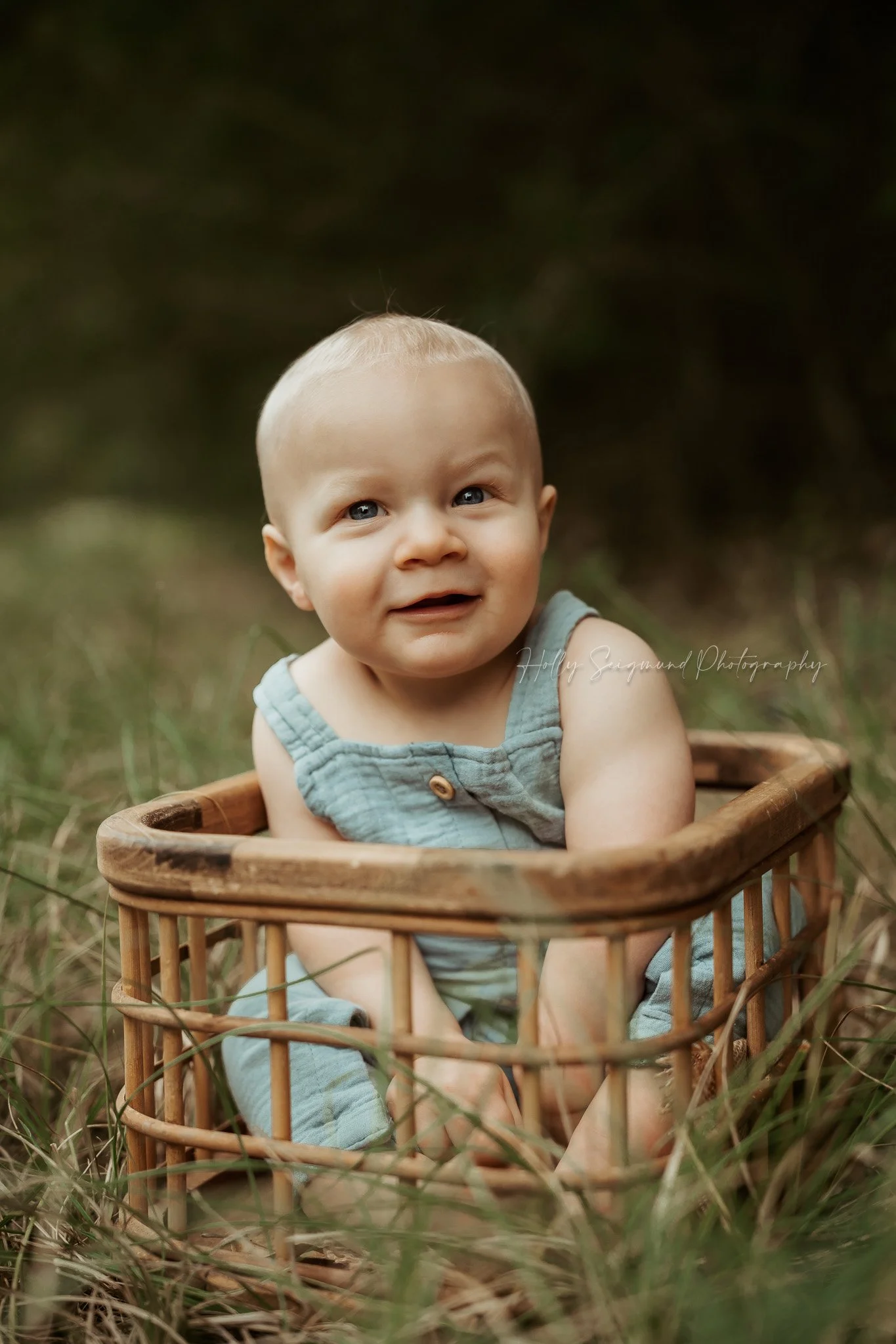 Baby boy in the grass for first birthday photos in Lee County, Texas