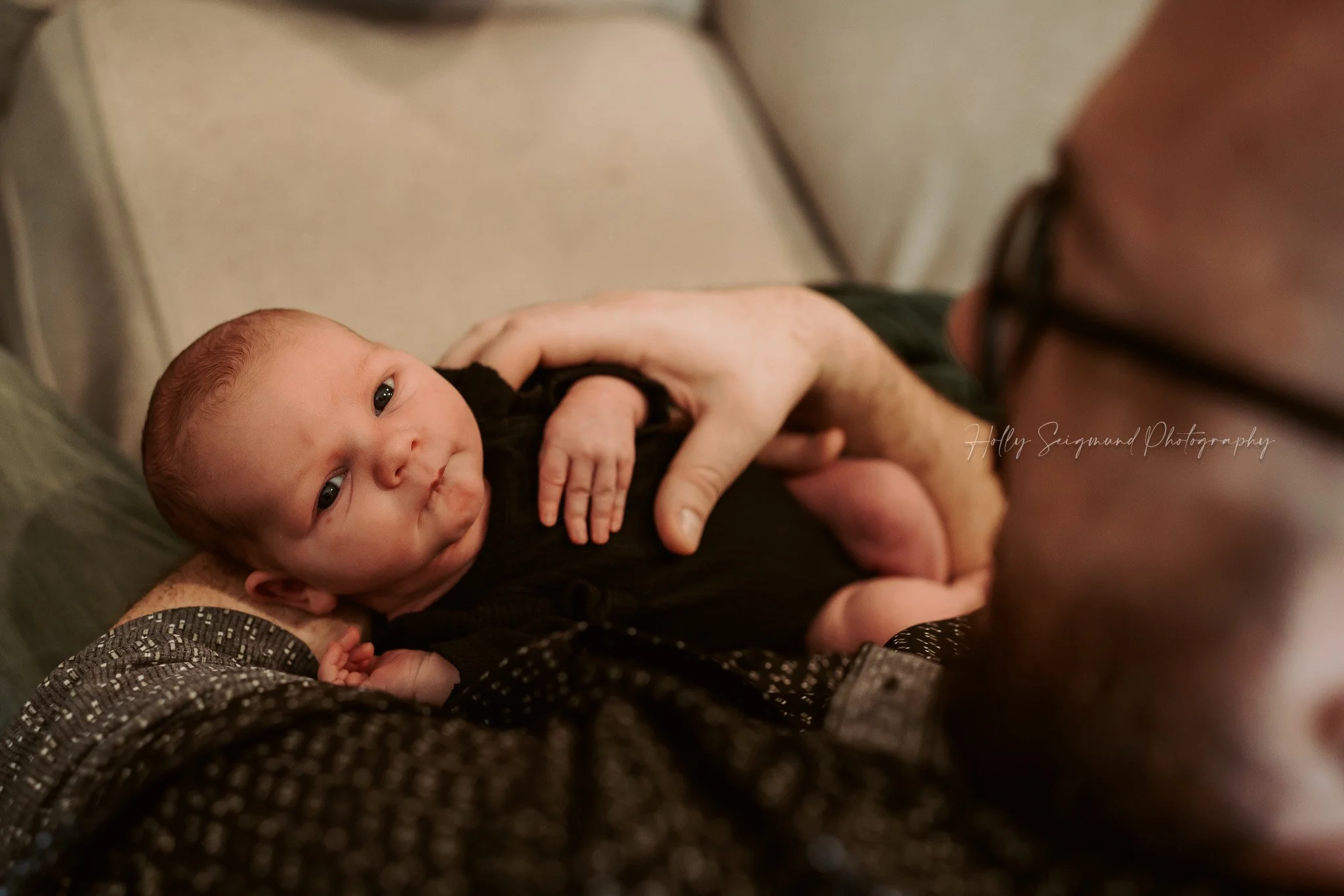 Dad's view of his newborn baby girl during a lifestyle session in Central Texas