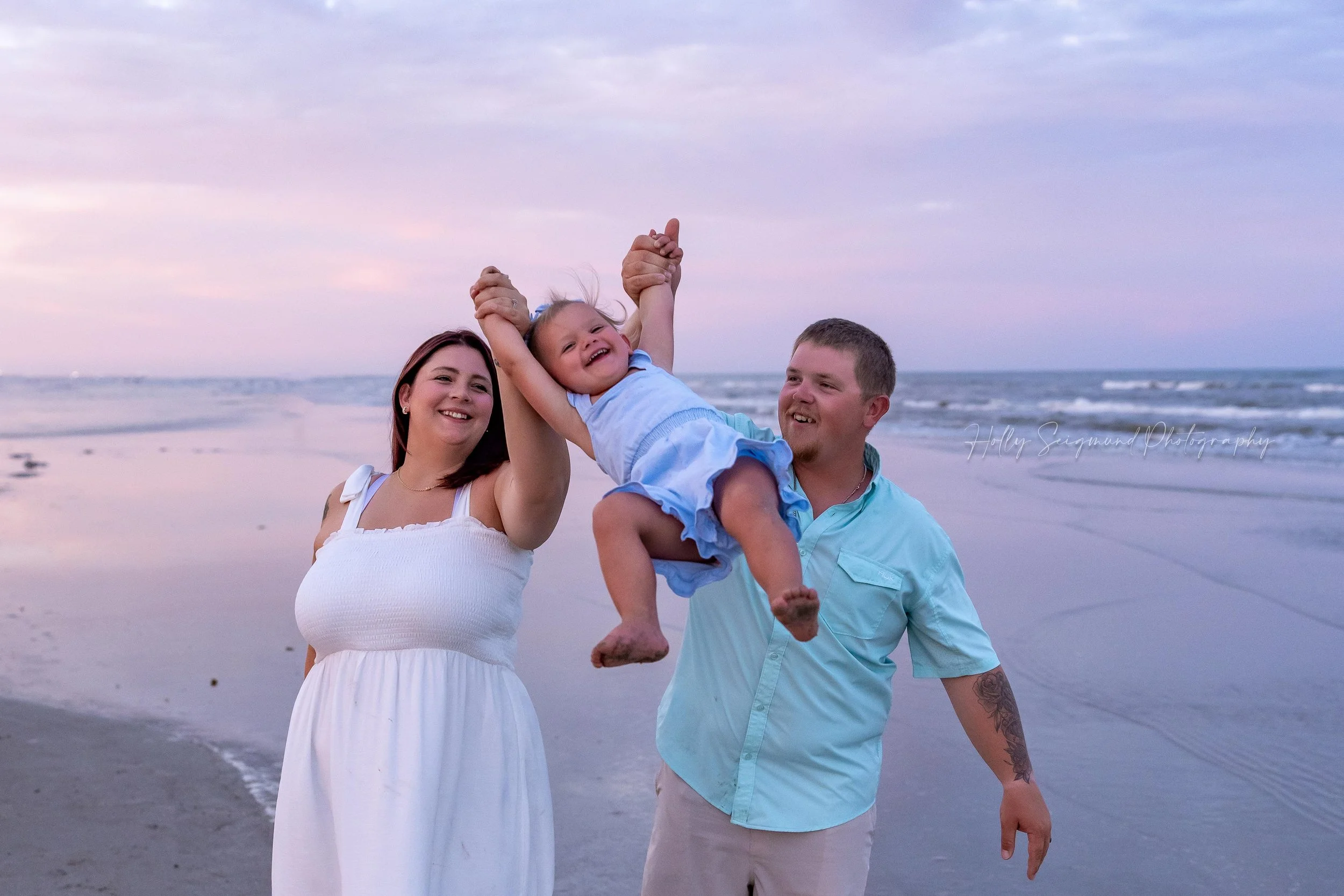 Family playing on Port Aransas beach with daughter during sunset beach photos