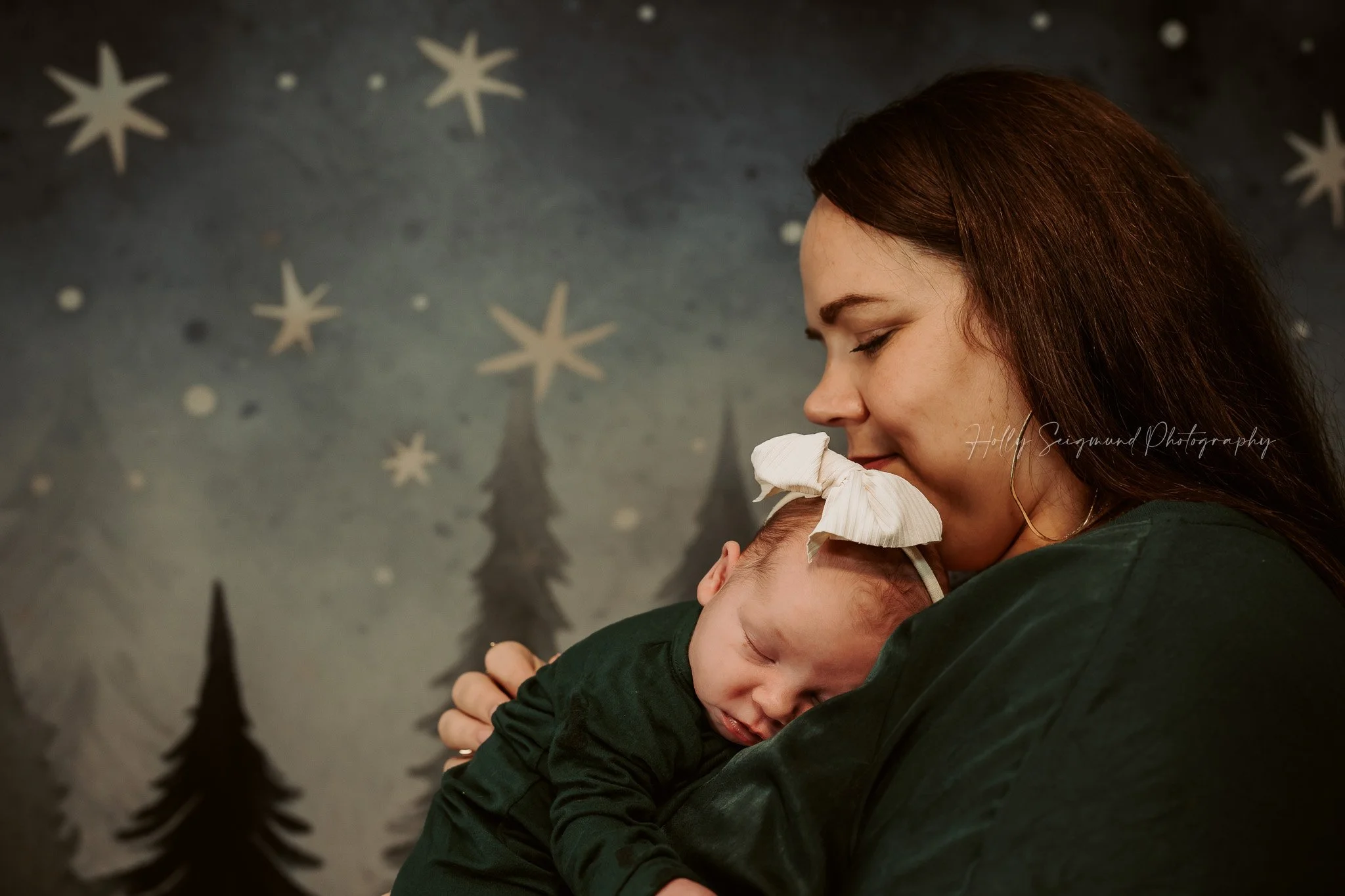 Mom and newborn in front of nursery wall in lifestyle newborn session in Central Texas