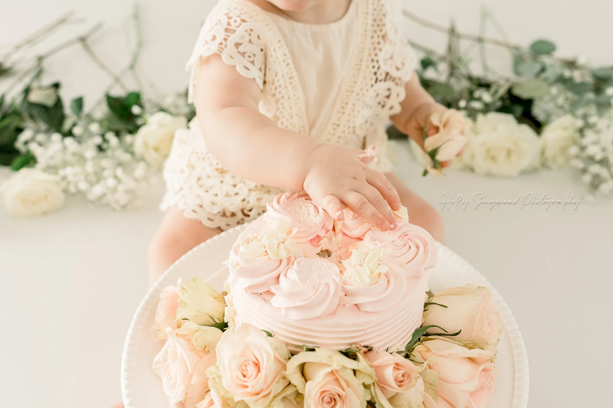 simple white and floral smash cake session in studio with natural light in Lexington, Texas
