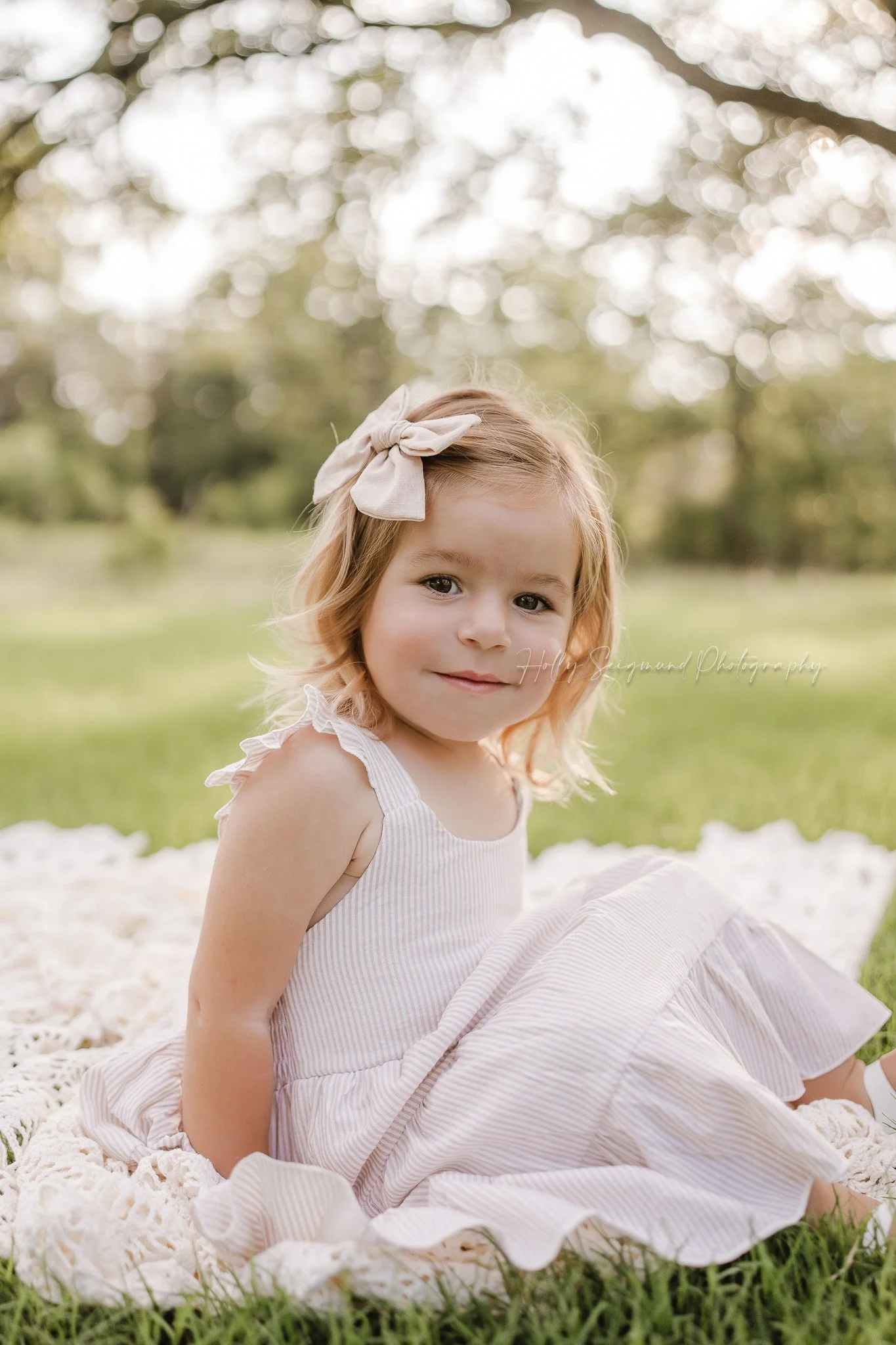 3-year-old girl posing with florals during a spring birthday photoshoot in Central Texas