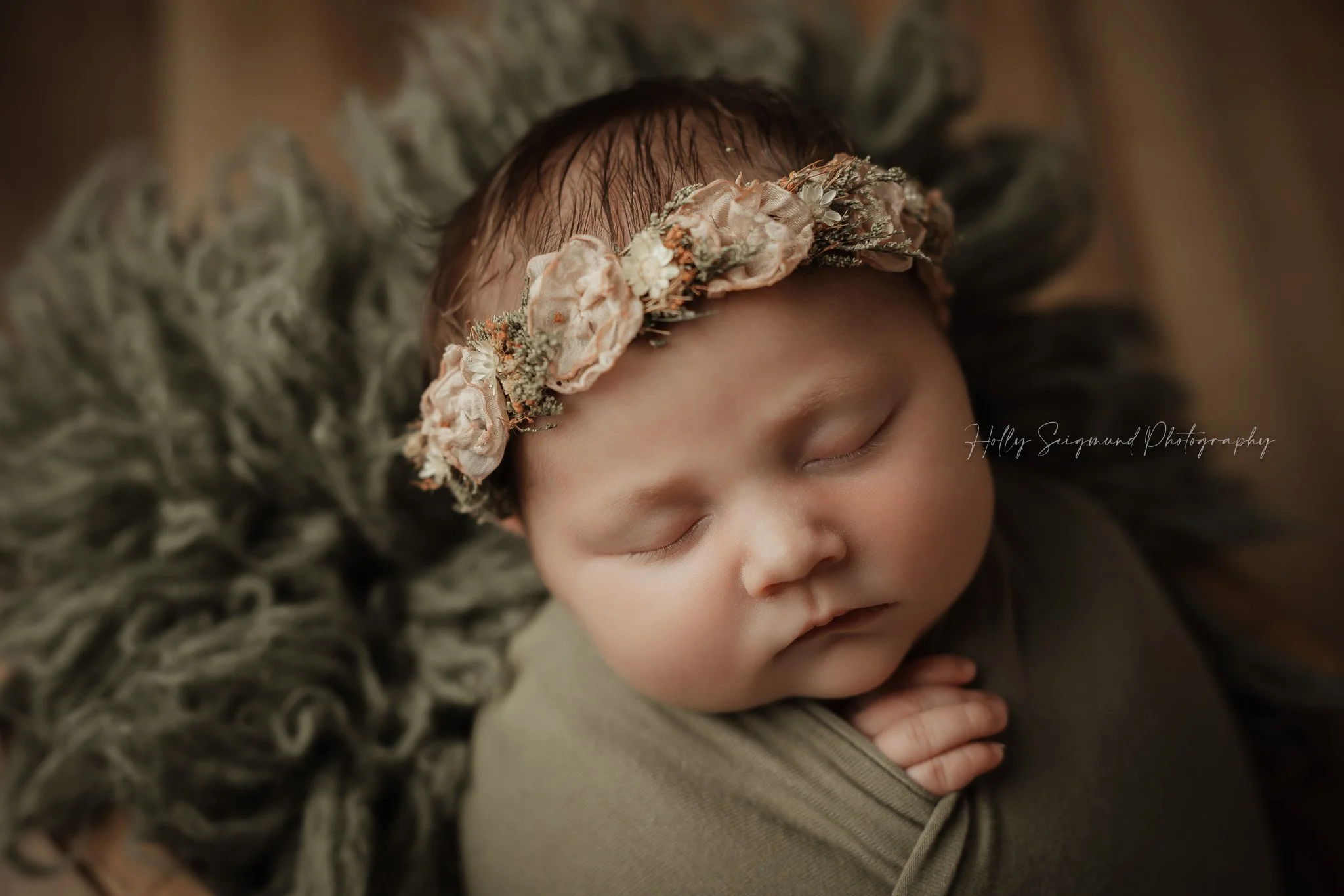 Pink and green floral crown on a newborn baby girl 78947