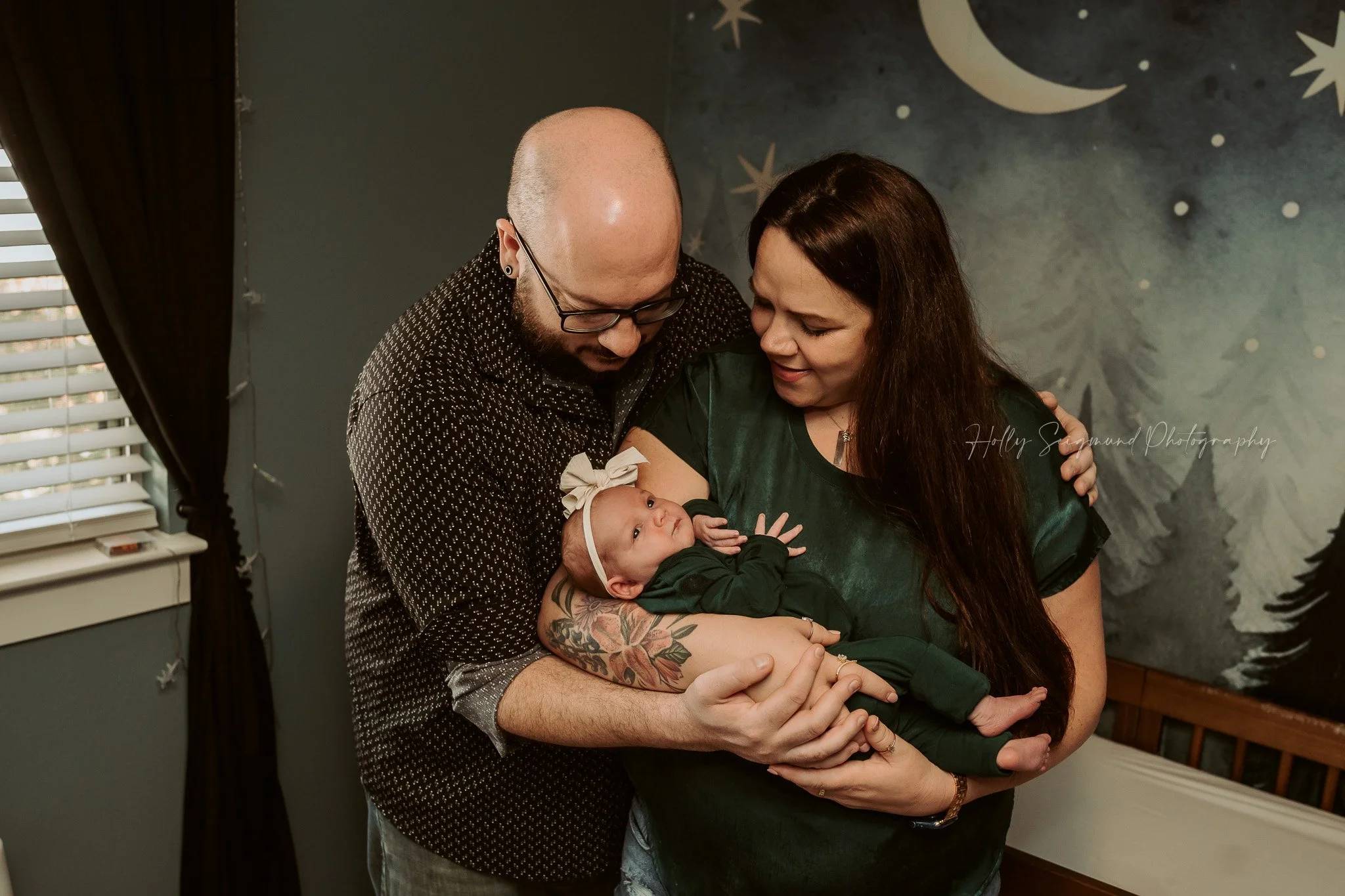 Family lifestyle newborn photo in baby's nursery with moody tones in Central Texas