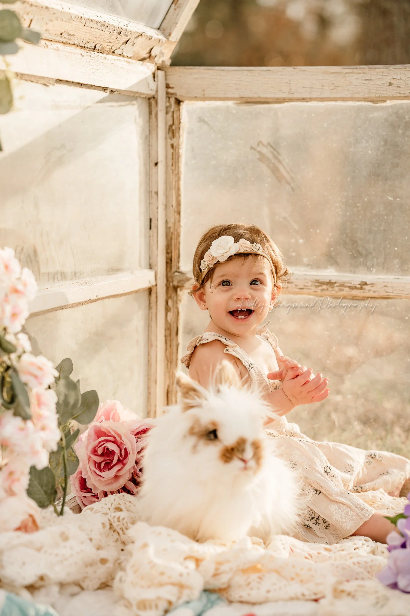 Baby girl with a bunny on vintage linens for first birthday photos in Central Texas