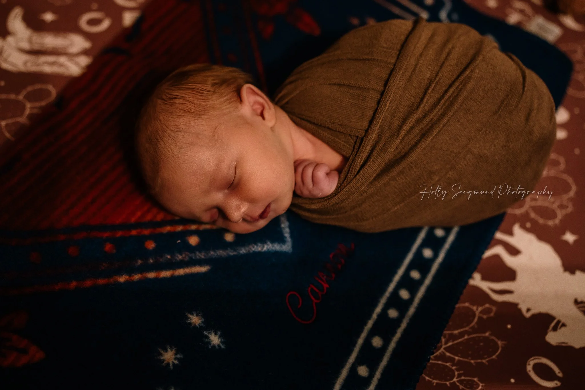 Newborn baby boy on his western blanket during his in-home newborn session in Central Texas