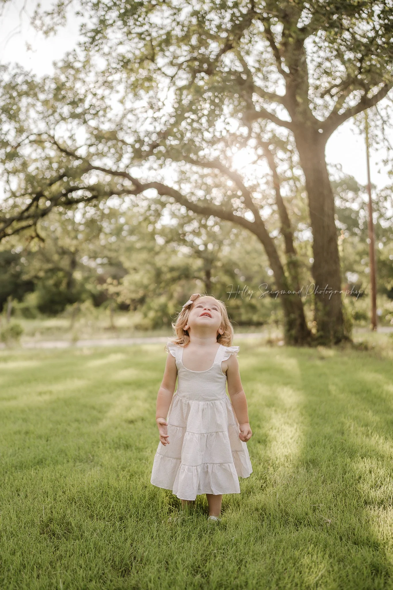 little girl turning three posing for a spring birthday photoshoot in Central Texas