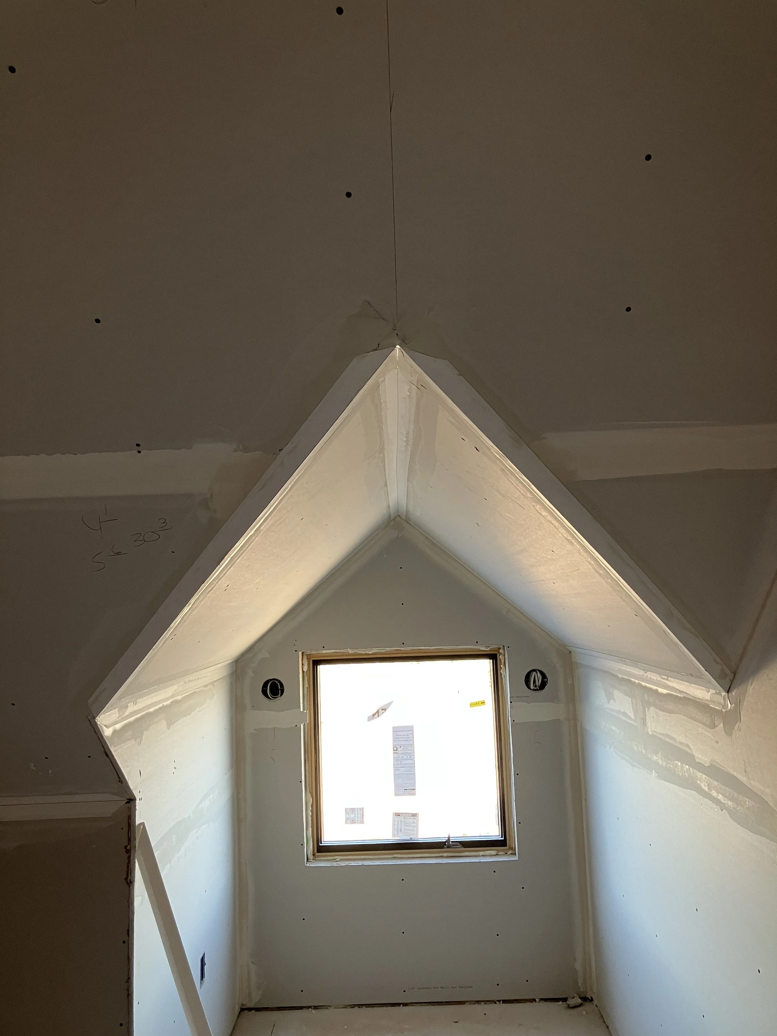 Attic room remodel with crisp drywall angles being finished in Bozeman, MT
