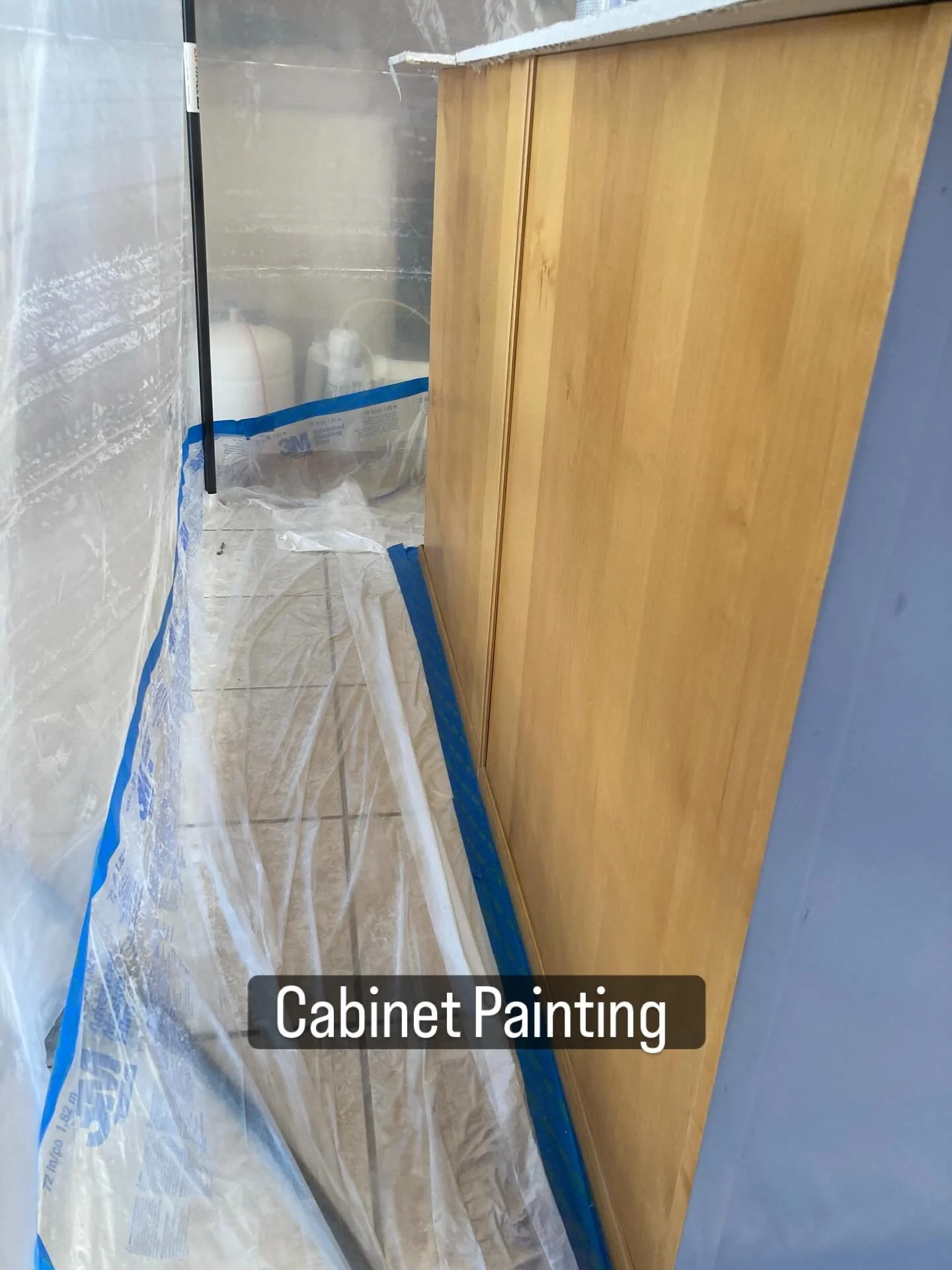Old oak cabinets masked and prepped for a modern painted finish by CKS Drywall