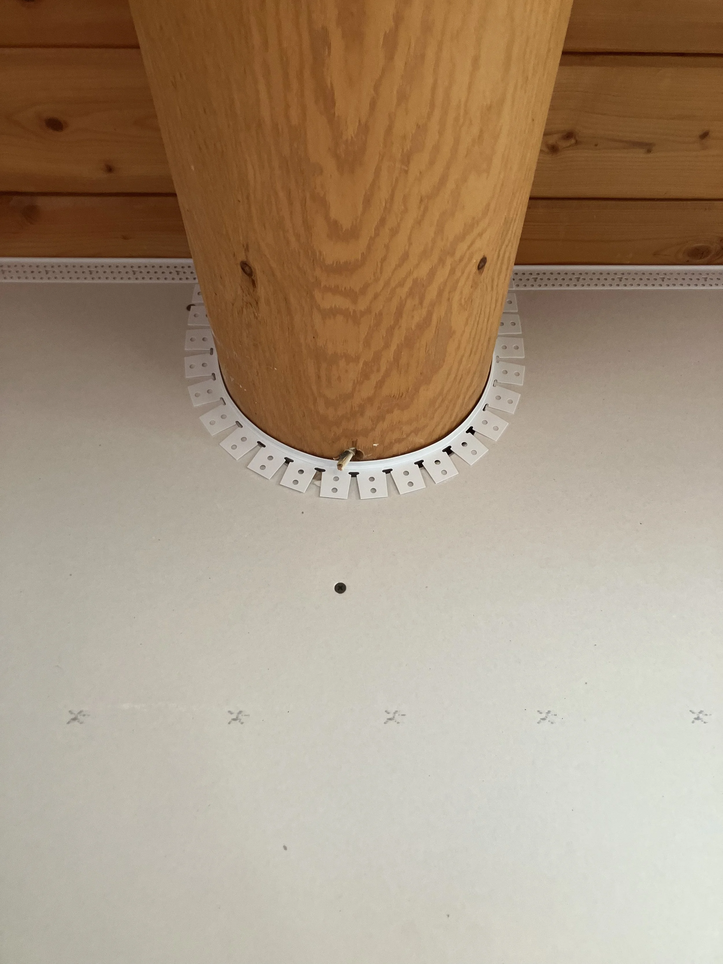 Stained log post and wood ceiling in a Montana home