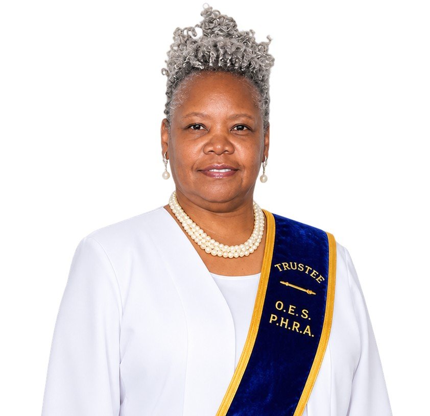 An older woman with gray dreadlocks styled up, wearing a white lace dress and a navy blue and gold sash with a star and the words 'G.S.G. C.' over her right shoulder, standing in front of a colorful, abstract background.