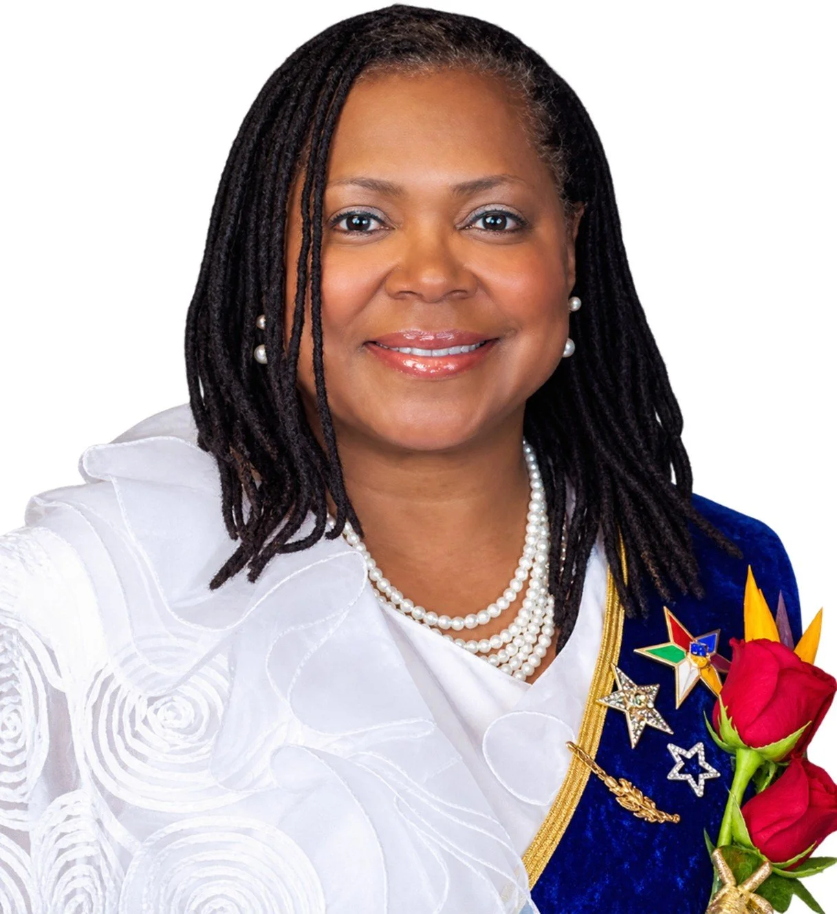 A woman with dark, shoulder-length hair in a white top, smiling, holding red roses against a colorful, abstract background.