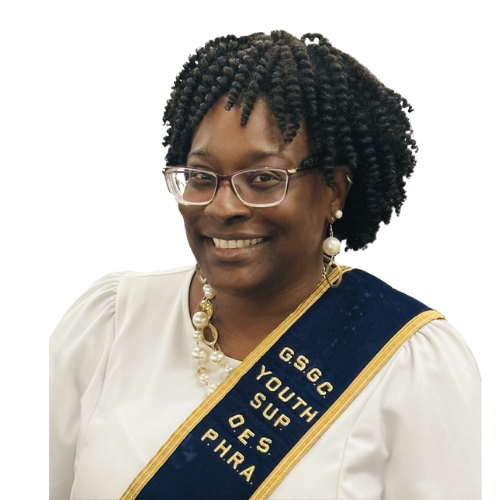 A woman with curly hair wearing glasses, a white dress, and a blue sash with gold trim that reads "G.S.G.C YOUTH SUP O.E.S. PHRA."
