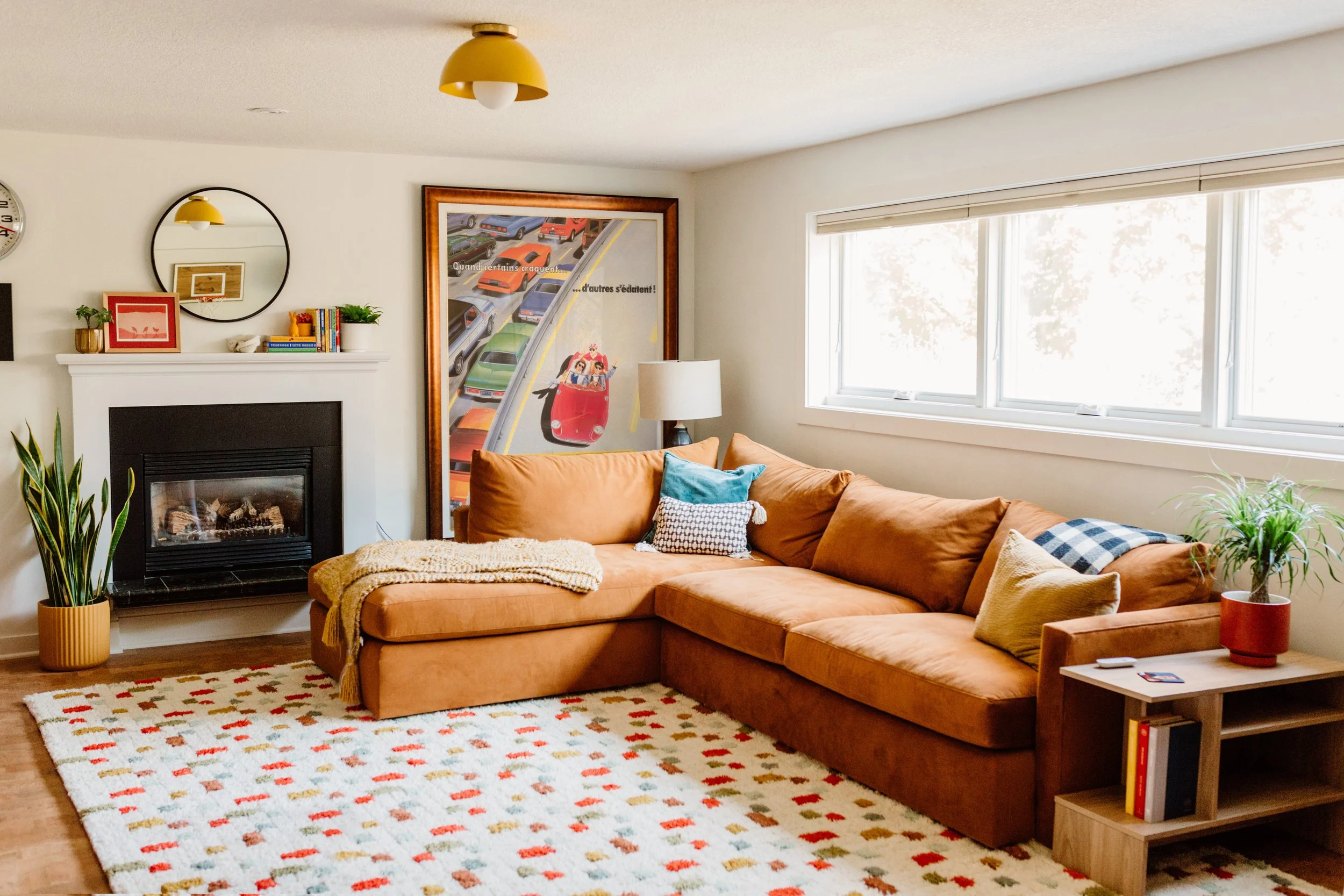 Fun and inviting basement designed for kids, with energetic colors, and comfortable spots for family time.