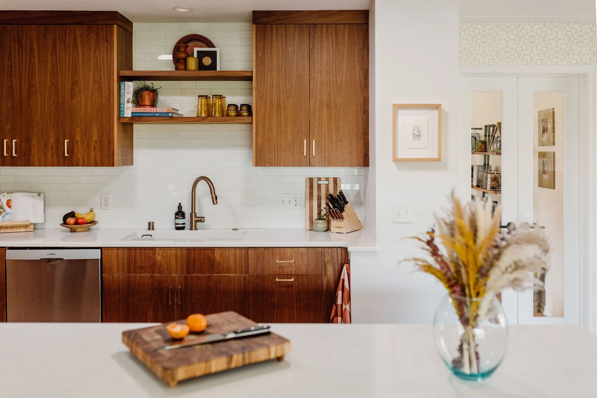 A mid-century modern kitchen features a large, 8-foot island for maximum workspace.