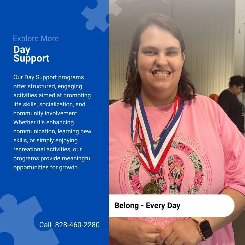 Young woman smiling, wearing medals around her neck, and pink shirt with a floral design, at an indoor event.