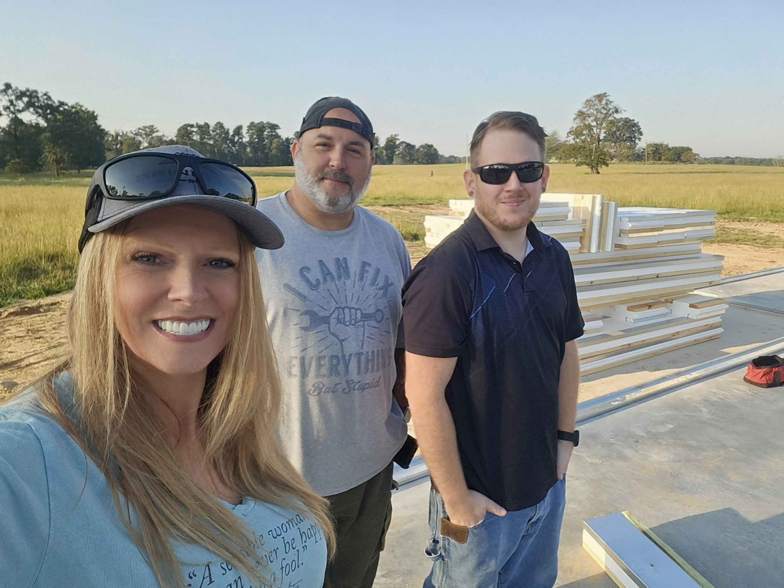Imprvious building and design founders on a Thermatech construction site with piles of Advanced Sip Pannels in the background.