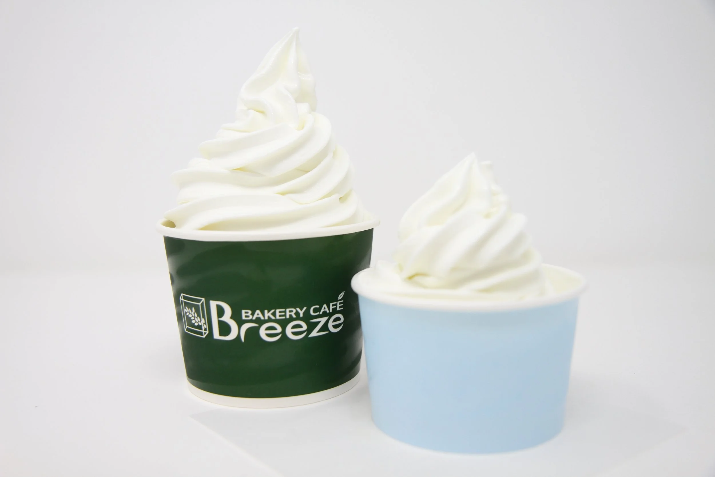 Frozen yogurt in insulated paper cup, two sizes of in-house made yogurt as soft serve.