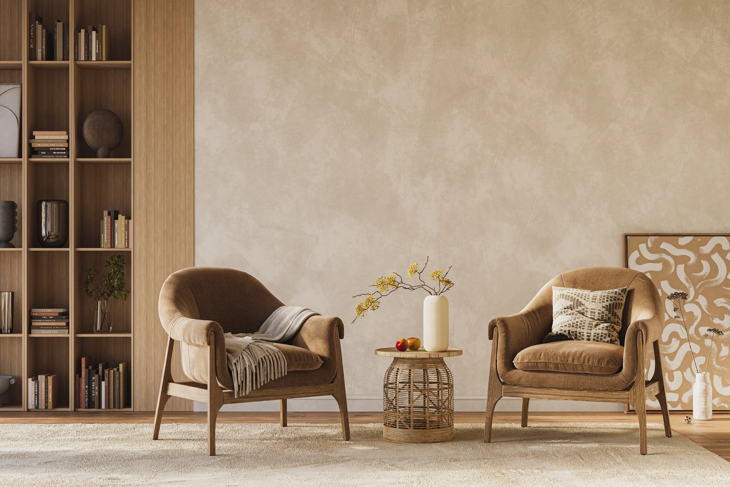 Living room with two brown armchairs, a wooden side table with a vase and apples, a wooden shelf with books and decor, beige wall with a framed artwork, and a cream carpet.