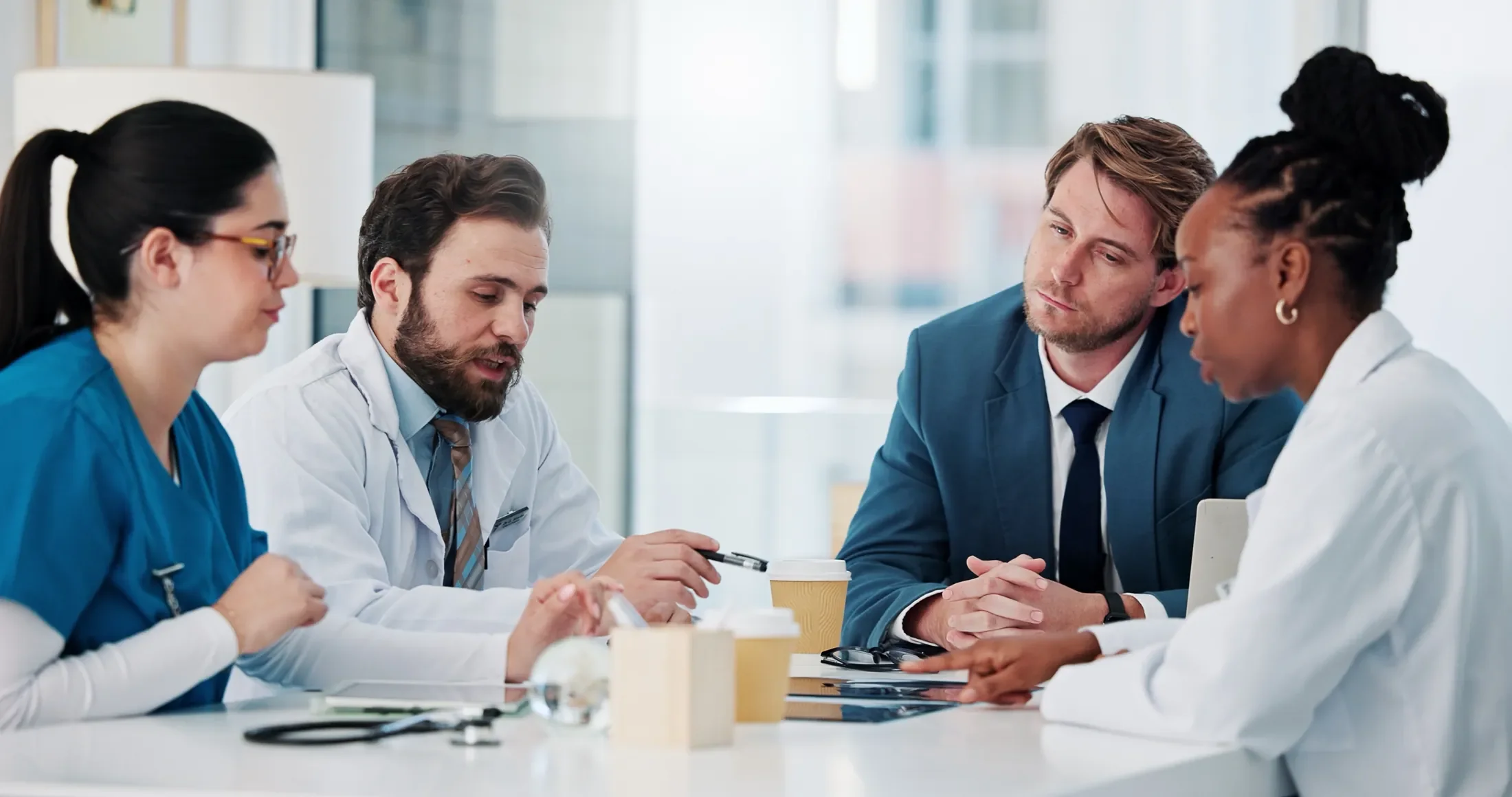 Clinicians and advisers in discussion around a meeting table