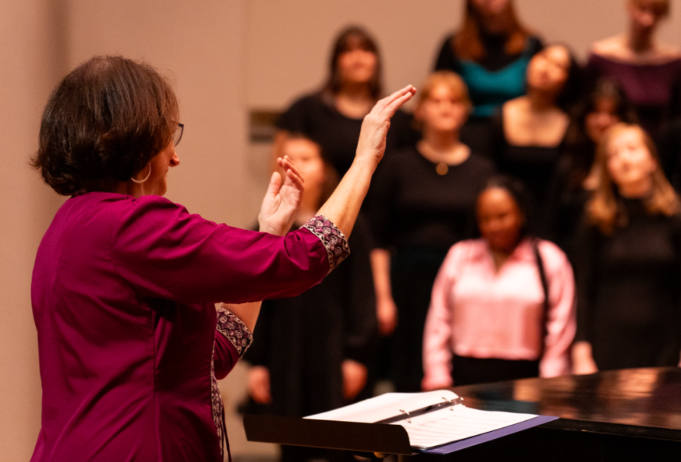 Close-up of Angela conducting a choir