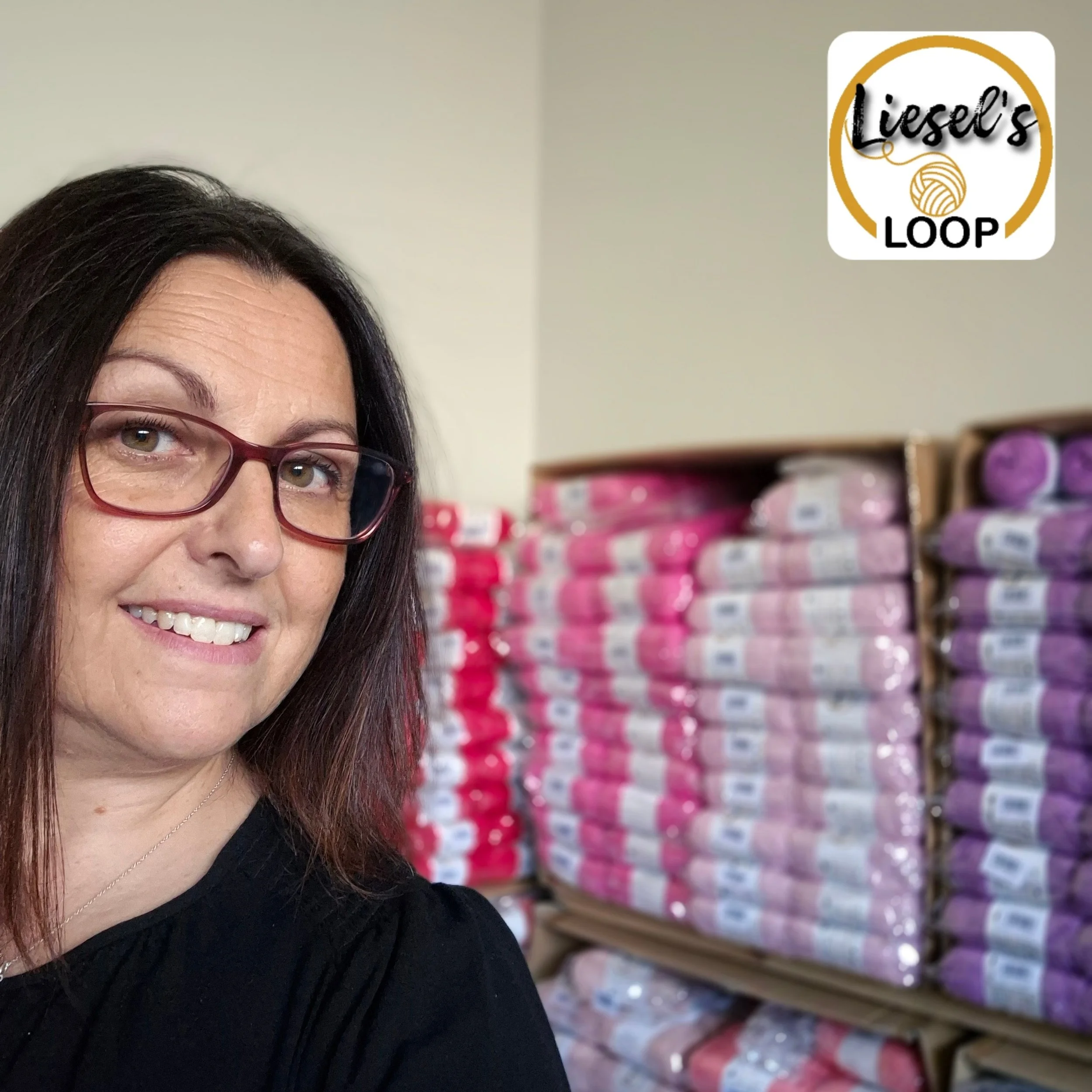 Close-up of a woman's face wearing glasses, smiling, with colorful yarn on shelves in the background, and a logo with yarn ball and the text 'Liesel's LOOP' in the top right corner.