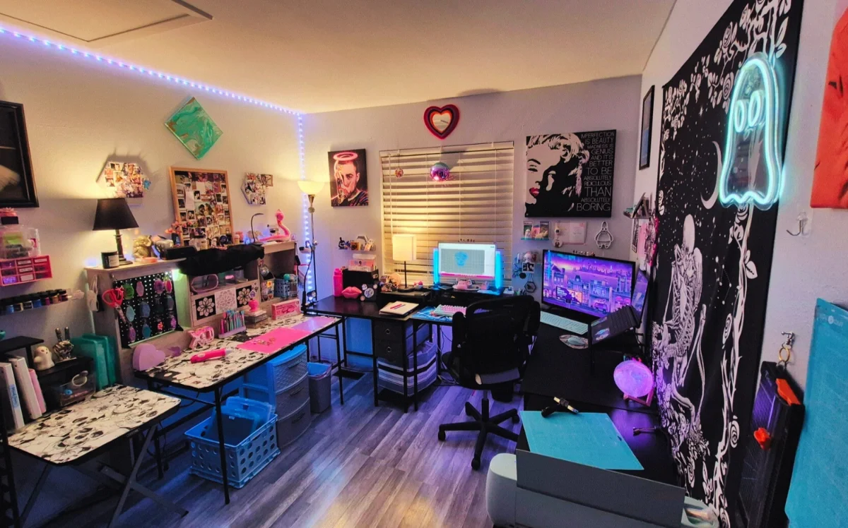 Colorful Aliidecalii workspace filled with art supplies, resin decor, neon lighting, and creative displays.