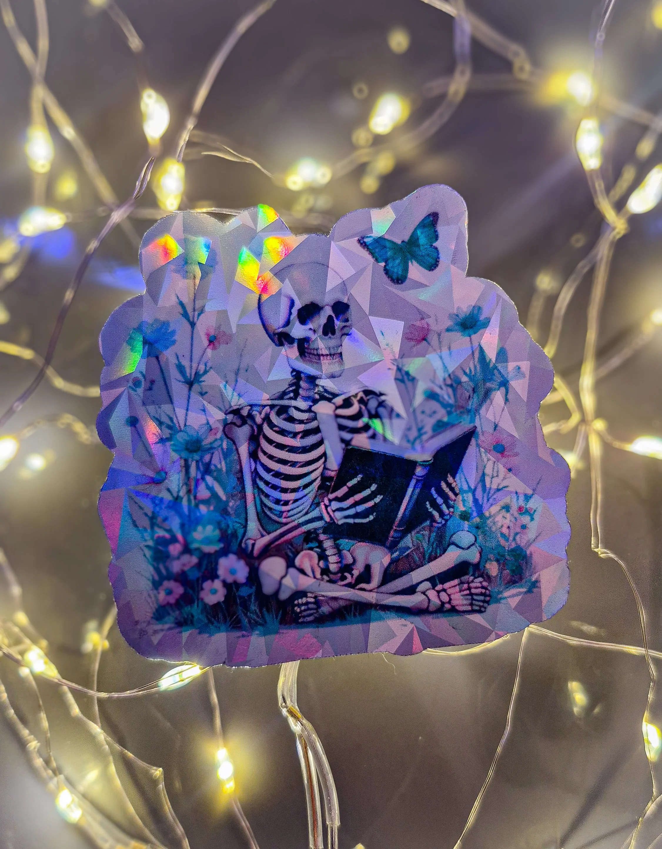 Stillness in Bloom — Skeleton Reading Holographic Vinyl Die-cut Sticker