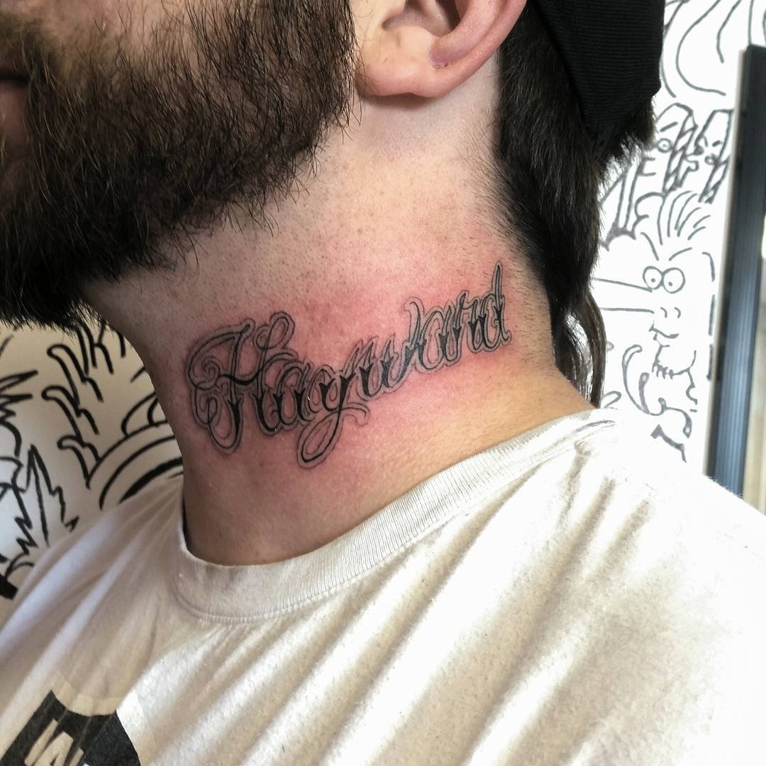 Tattoo of the name 'Hayward' in cursive script on the back of a person's neck.