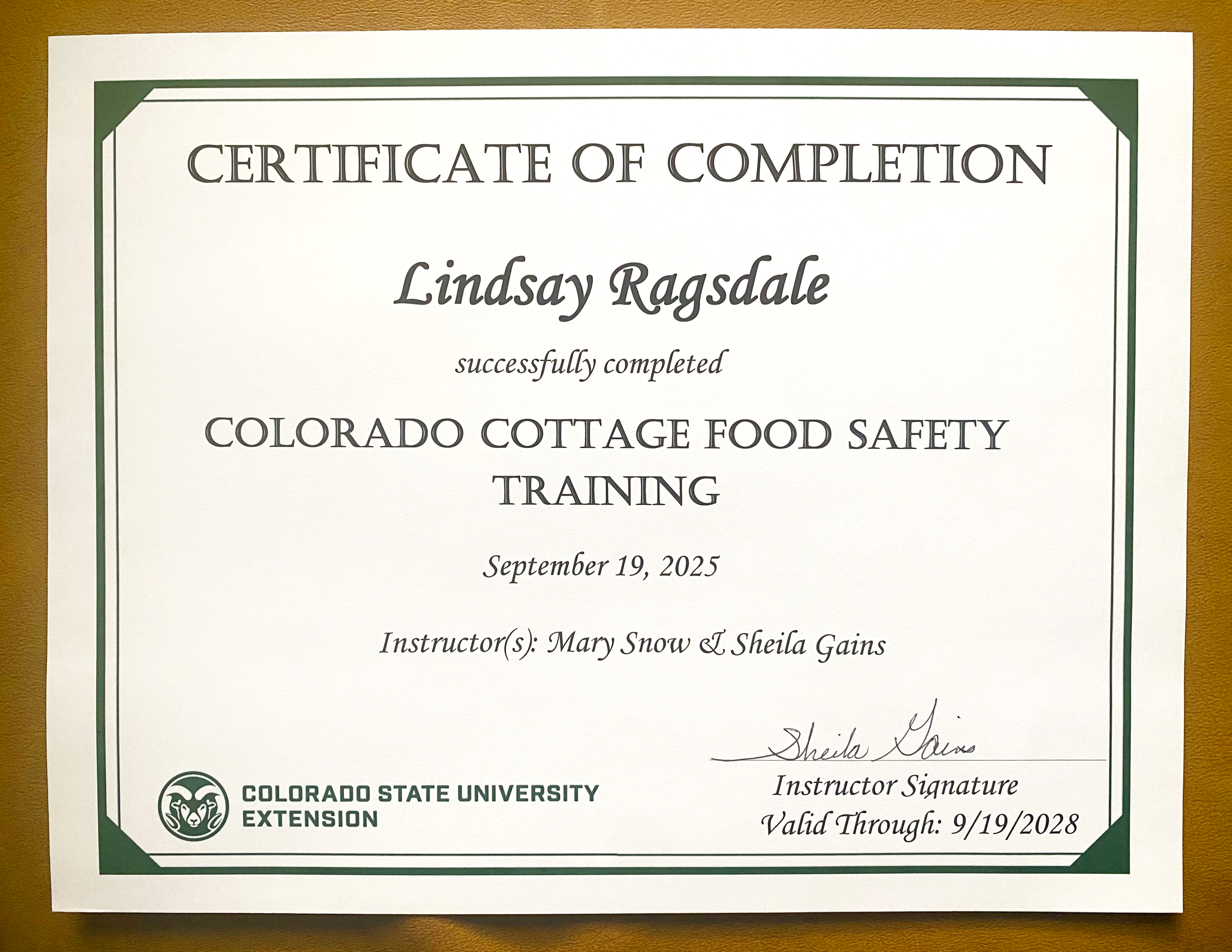 Image of a certificate of completion from Colorado State University Extension stating the eligibility to sell food directly to consumers in Colorado under the Cottage Food Act.