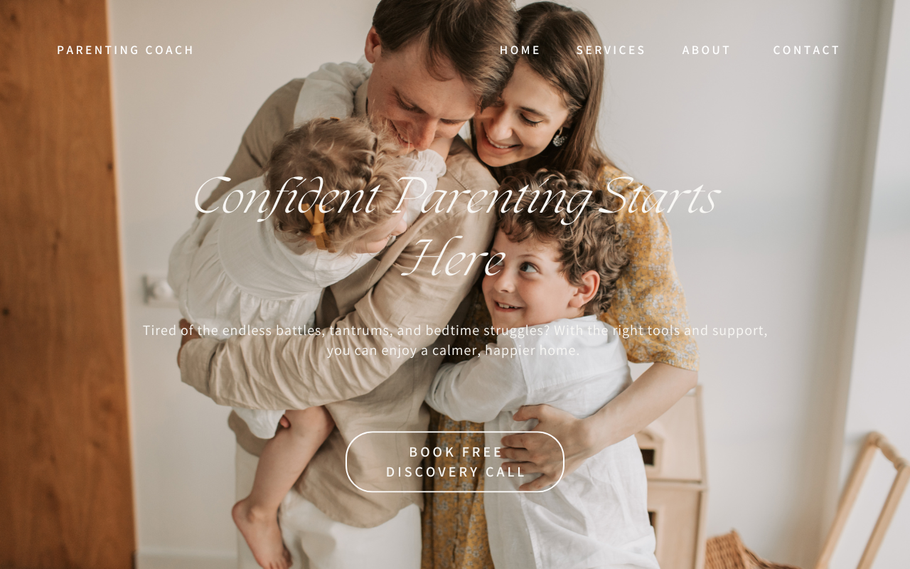 Happy family of four hugging in a warmly lit room, mother and father with two young children, smiling and enjoying a moment together.