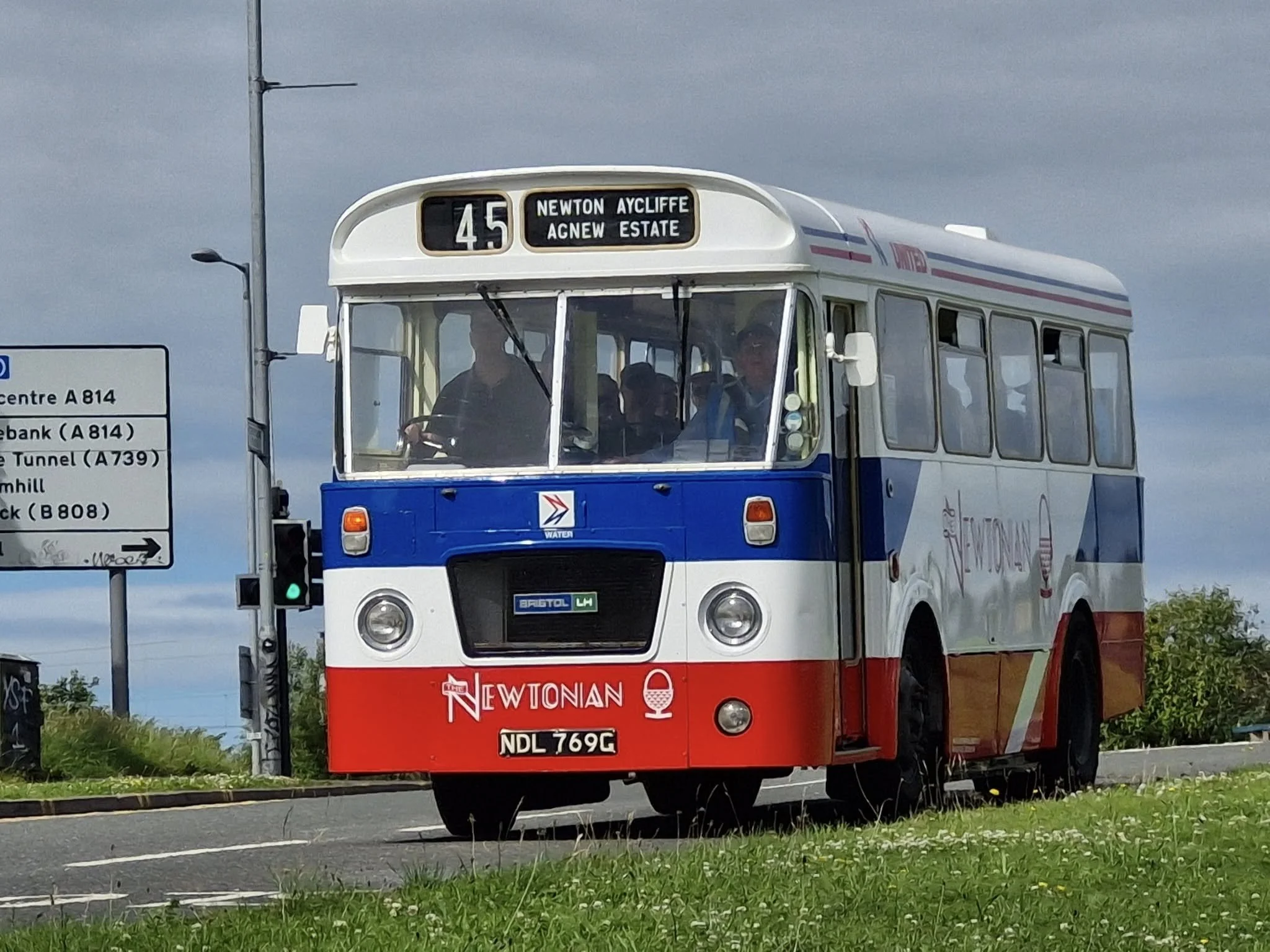 Double-decker bus painted in red, white, and blue with