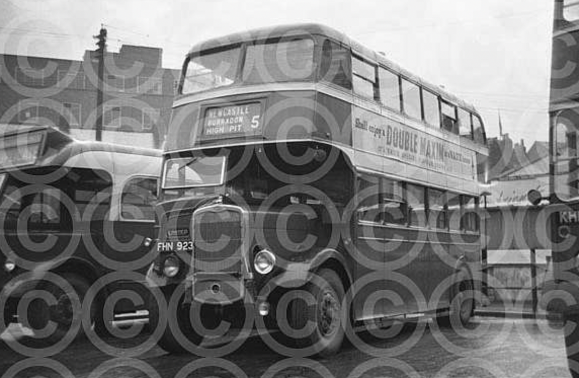 Black and white photo of a vintage double-decker bus and a car parked on the street