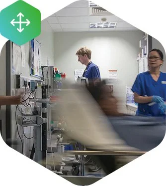 Healthcare professionals attending to a patient in a hospital room