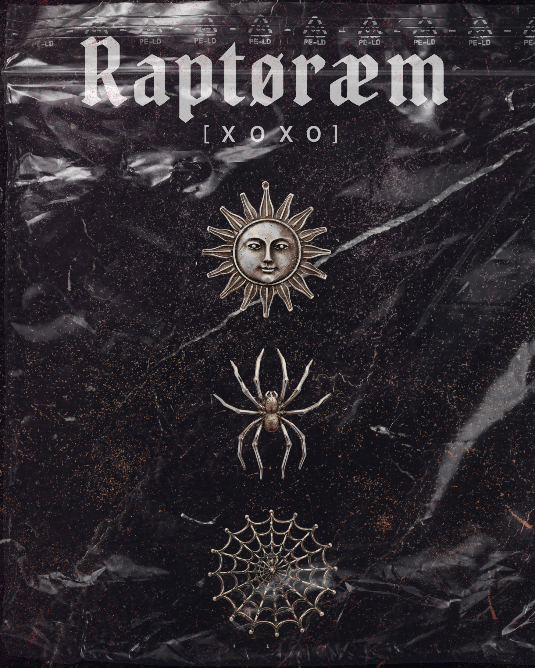 Decorative Halloween-themed jewelry set with a silver sun face pendant, a spider, and a spider web, displayed on a textured black background with a plastic wrapping.