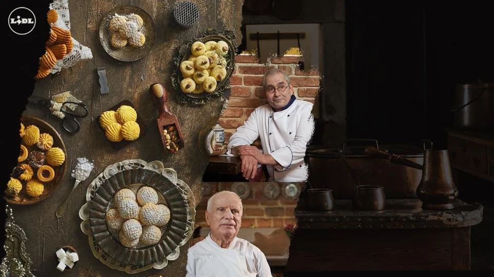 Two senior male chefs in a rustic kitchen with baked goods and cookies on a wooden table and shelves.