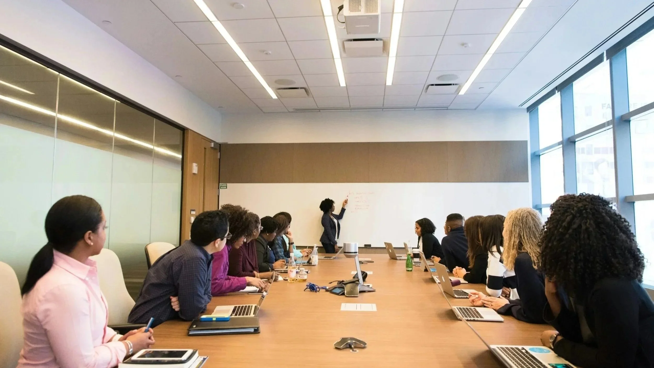 Diverse team of executives in a boardroom meeting, representing ExecuComp Consulting's high-impact executive advisory services
