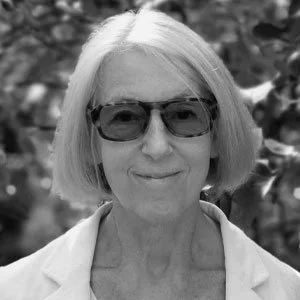 A woman with shoulder-length hair wearing sunglasses and a light-colored shirt, outdoors with blurred foliage in the background. PolMusicA. Competition. Young talents. Australia. Melbourne, Sydney, Brisbane, Adelaide, Perth. Victoria, NSW, Queensland